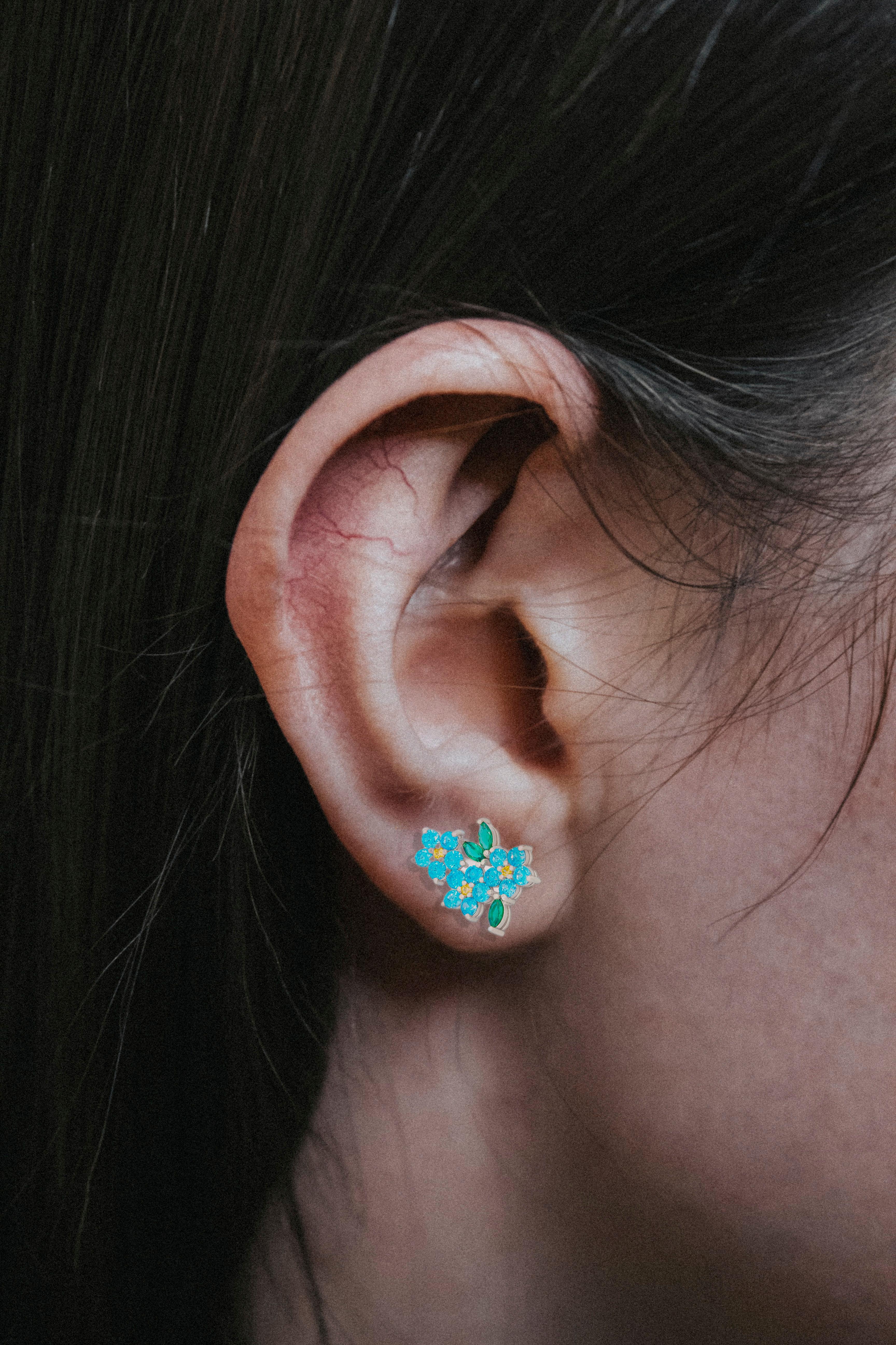 Mismatched flower earrings with colored gemstones in 14k gold.
Forget me know flower 14k gold earrings studs. Cornflower earrings studs. Blue topazes and yellow sapphires studs. 

Weight: 2.3 g.
Metal: 14k solid gold
Earrings goes with gold