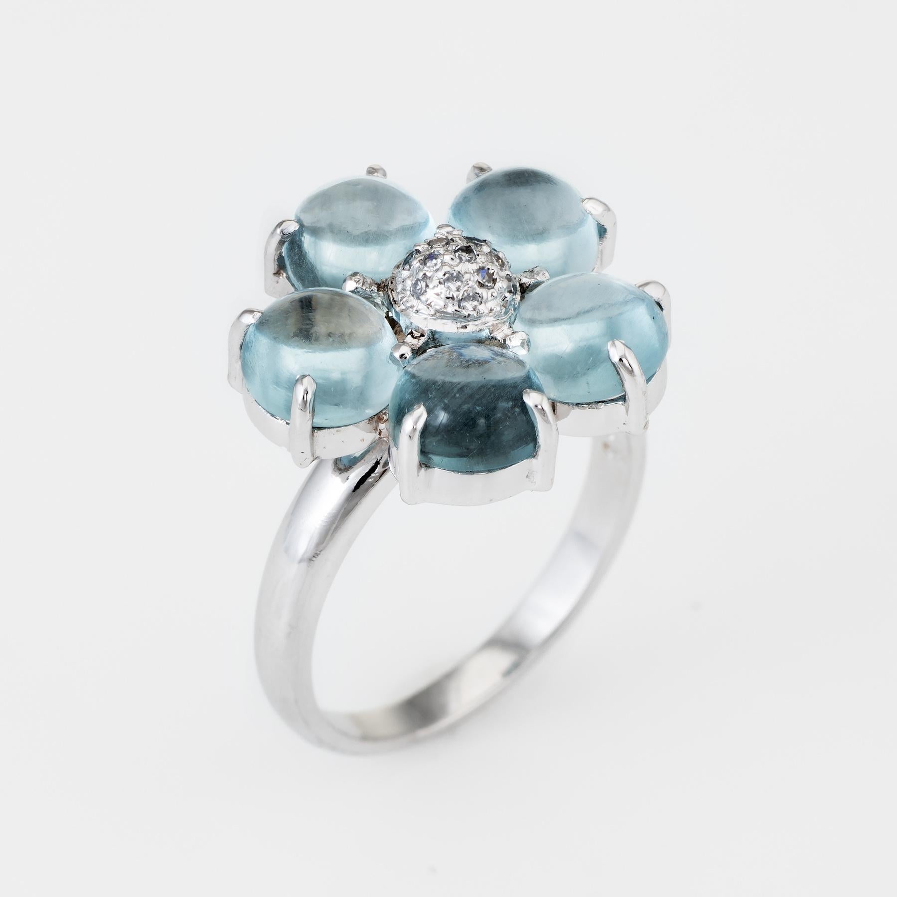 Charming vintage forget me not cocktail ring, crafted in 14 karat white gold. 

Cabochon cut aquamarines each measure 6mm (estimated at 1.25 carats each - 6.25 carats total estimated weight), accented with an estimated 0.13 carats of pave set single