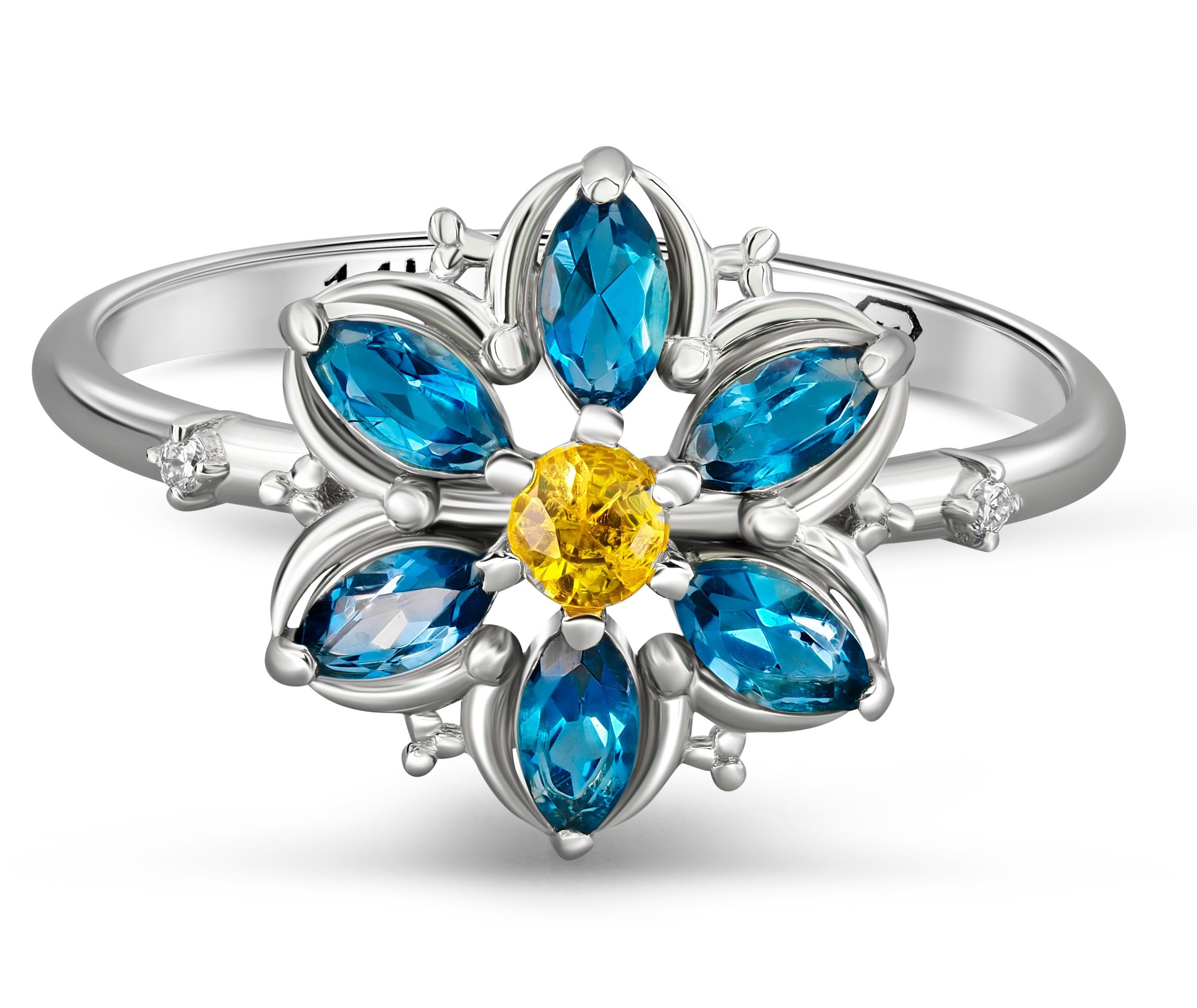 Forget Me Not gold ring with topaz. 
Marquise topaz ring. Sky blue topaz ring. Floral Band With topazes and sapphire. Alaska floral ring.

Weight: 1.8 g. depends from size
Metal - 14k gold.

Sapphire: cut - round, weight - 0.25, color : yellow,