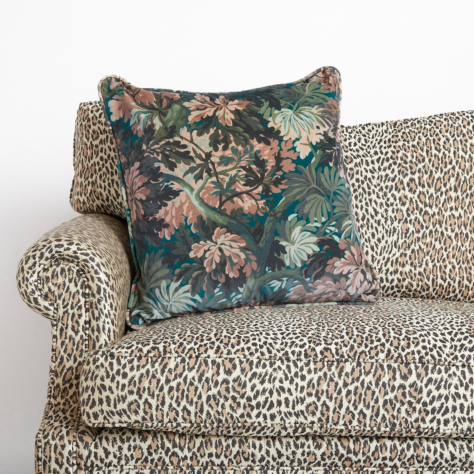 Transcend to the woodland of Shakespeare and merry England with FORIS; a verdant print depicting a grove of ancient oak trees. This luxurious velvet piped cushion is plumped with sumptuously soft responsibly sourced British wool.

Each cushion sold