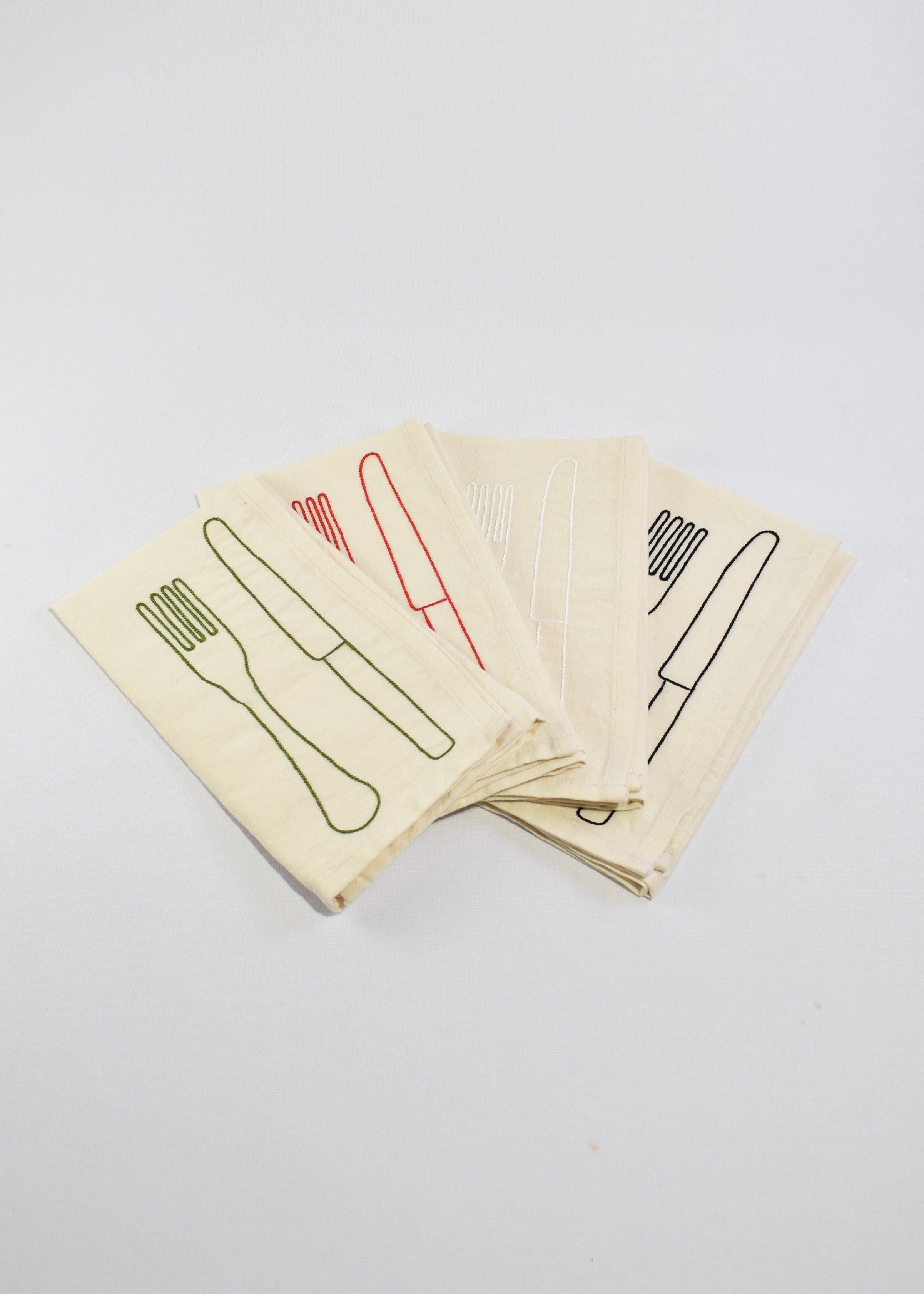 Beautiful antique French linen and cotton napkins embroidered with colored cotton thread featuring a fork and knife in a set of four.

Each set contains four different colors of embroidery - green, red, white, and black. Designed by Sarah Espeute