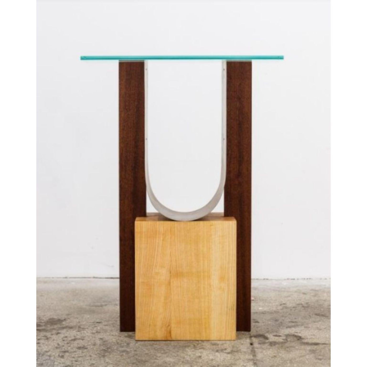 Form 3 by Radu Abraham
A limited series of 10, that is currently at nr.2
Materials: Lemn Frasin, Lemn Mahon, Tabla Otel, Sticla
Dimensions: 50 x 20 x 70 cm

Massive cube of ash wood, with mahogany sides, a thin sheet of bended steel, and a