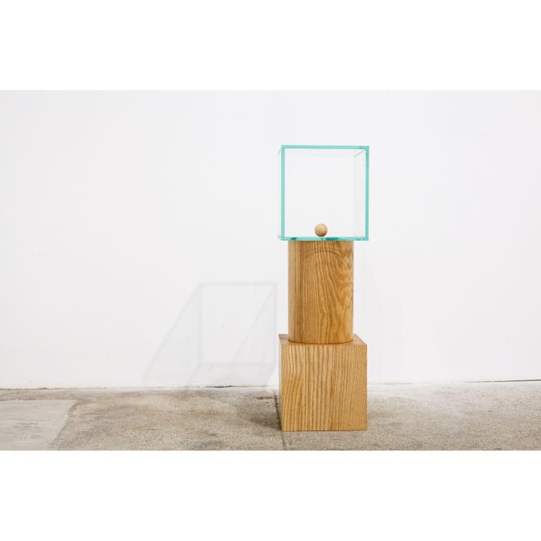 Form 5 by Radu Abraham
A limited series of 10, currently at nr. 2
Materials: Ash wood, glass
Dimensions: 25 x 25 x 82 cm

Massive cube-shaped block of ash wood, with a cylinder of the same wood, and a glass cube with two-part
