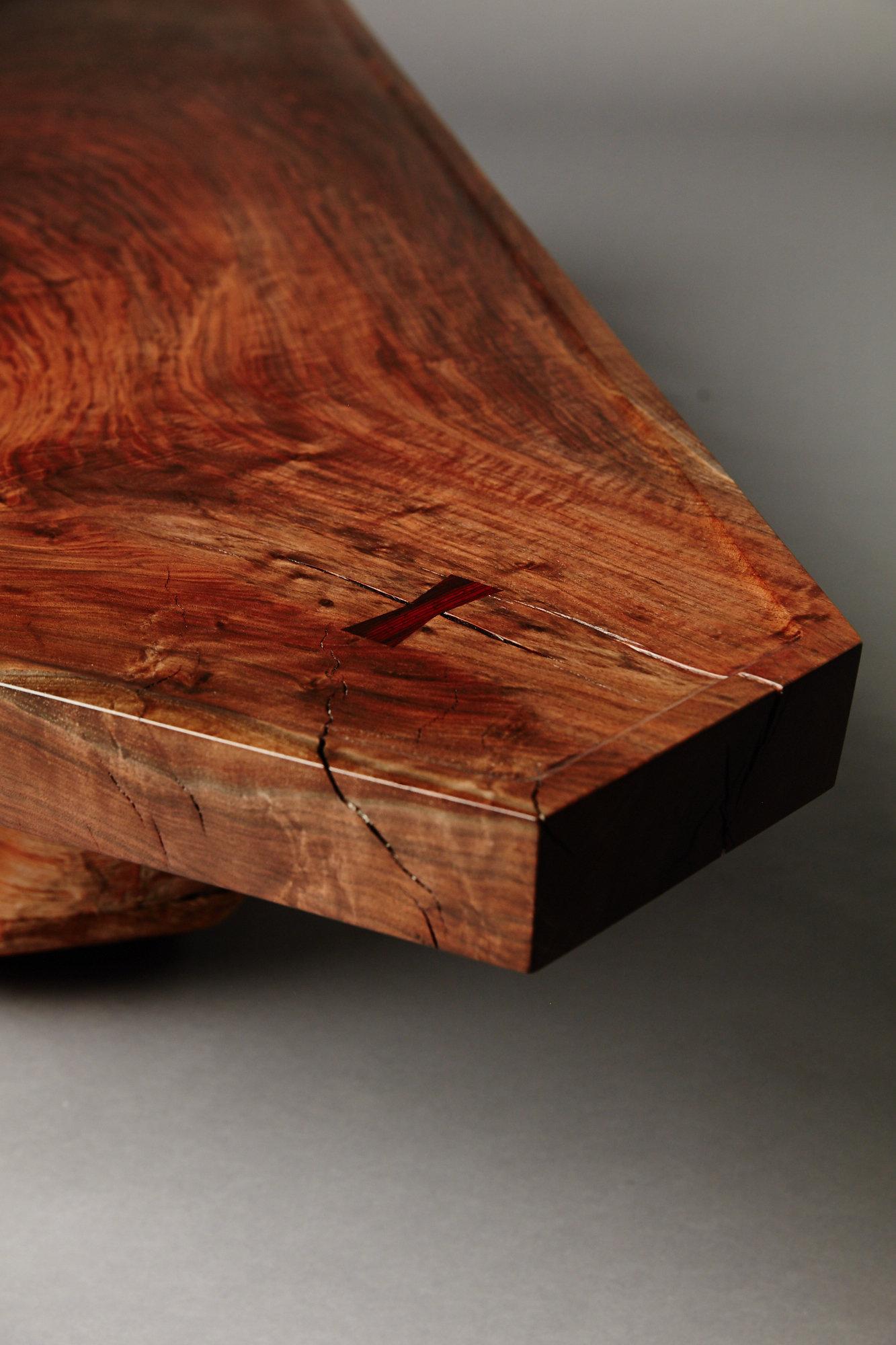 Sculptural coffee table featuring a single slab claro walnut top and a hand-shaped old growth redwood base.