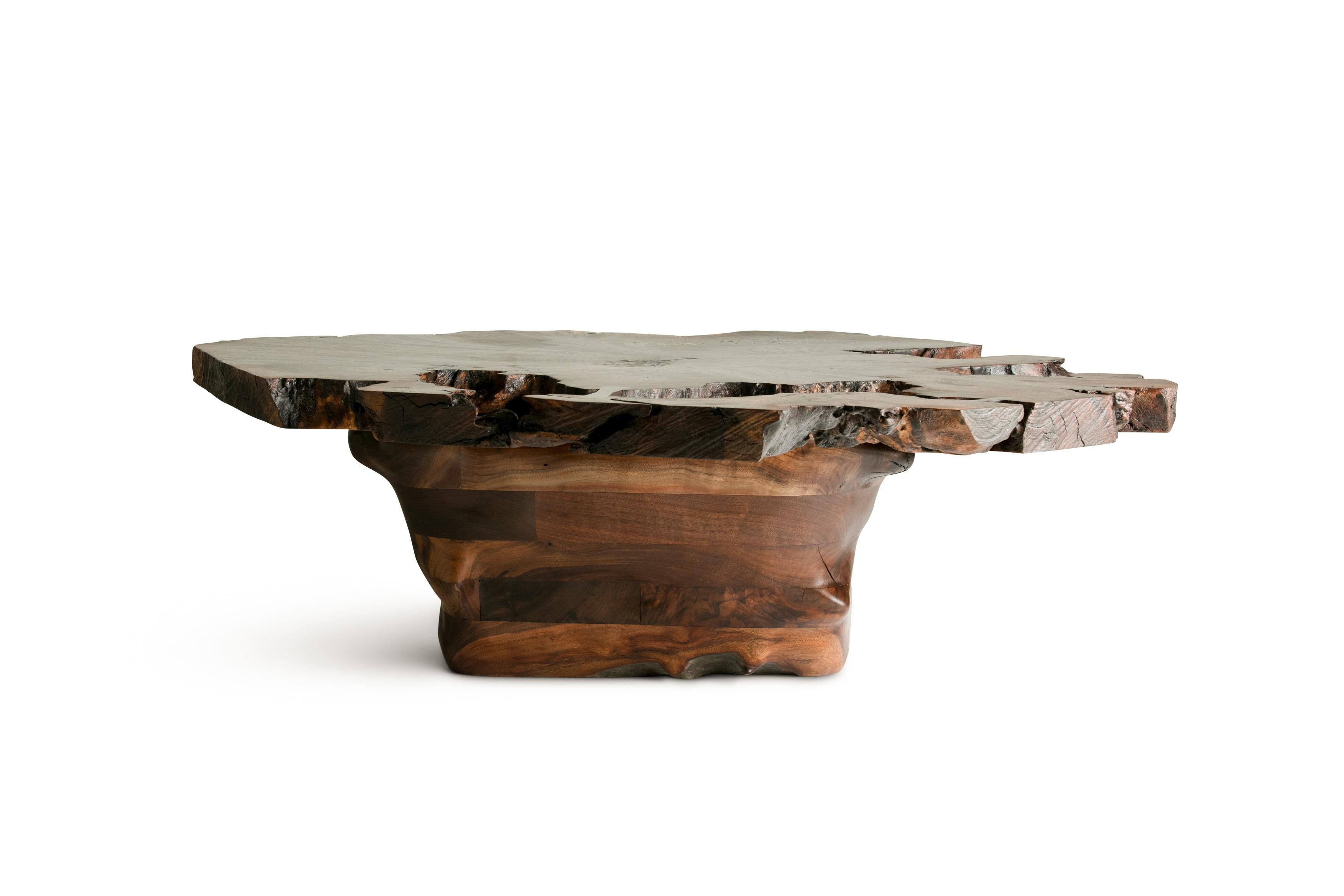 Sculptural coffee table featuring a claro walnut root, cross section top with a hand carved claro walnut base.