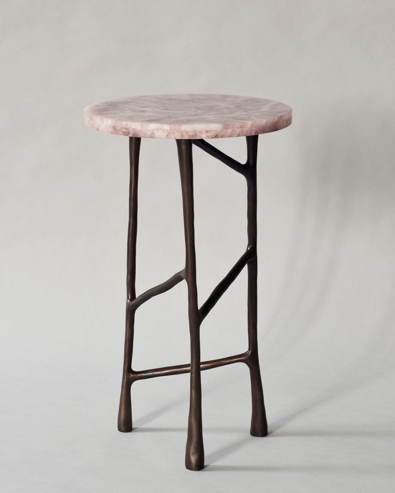 The Forma side or drinks table by DeMuro Das has a top in pink quartz and a sculptural hand cast base in solid antique bronze.