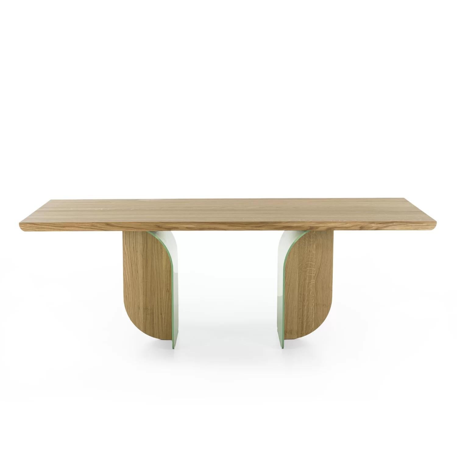 Table with a solid wood top with glued slats, with rounded corners, characterized by its legs, born from the union of iron and wood and created to look different depending on which angle they’re seen from.

Available in a variety of different sizes