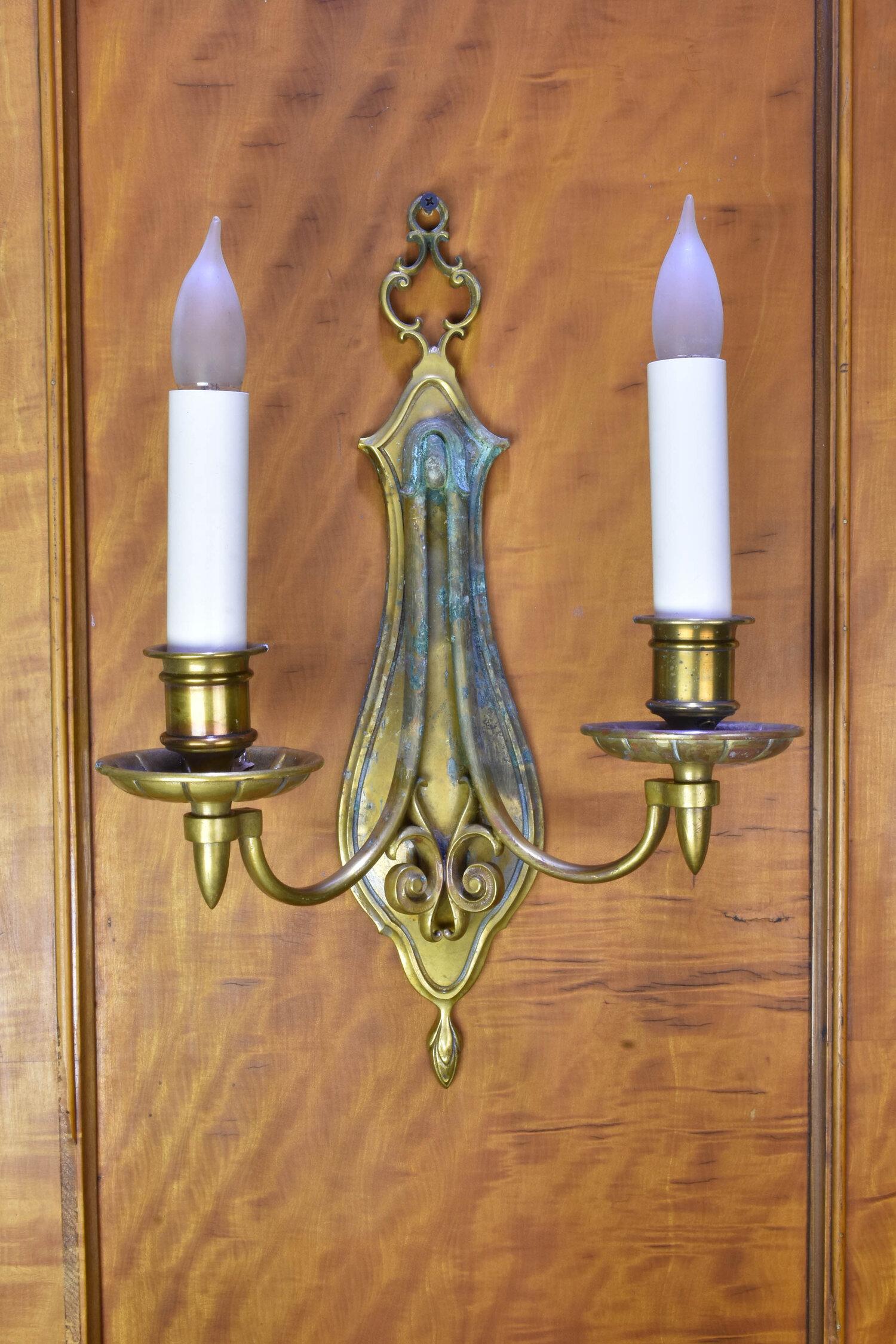 These bronze/brass sconces circa 1900s are by Bradley & Hubbard, a company known for their quality of craftsmanship. Although Nathaniel Bradley, William Bradley, and Walter Hubbard started their Connecticut-based company in 1852, they did not begin