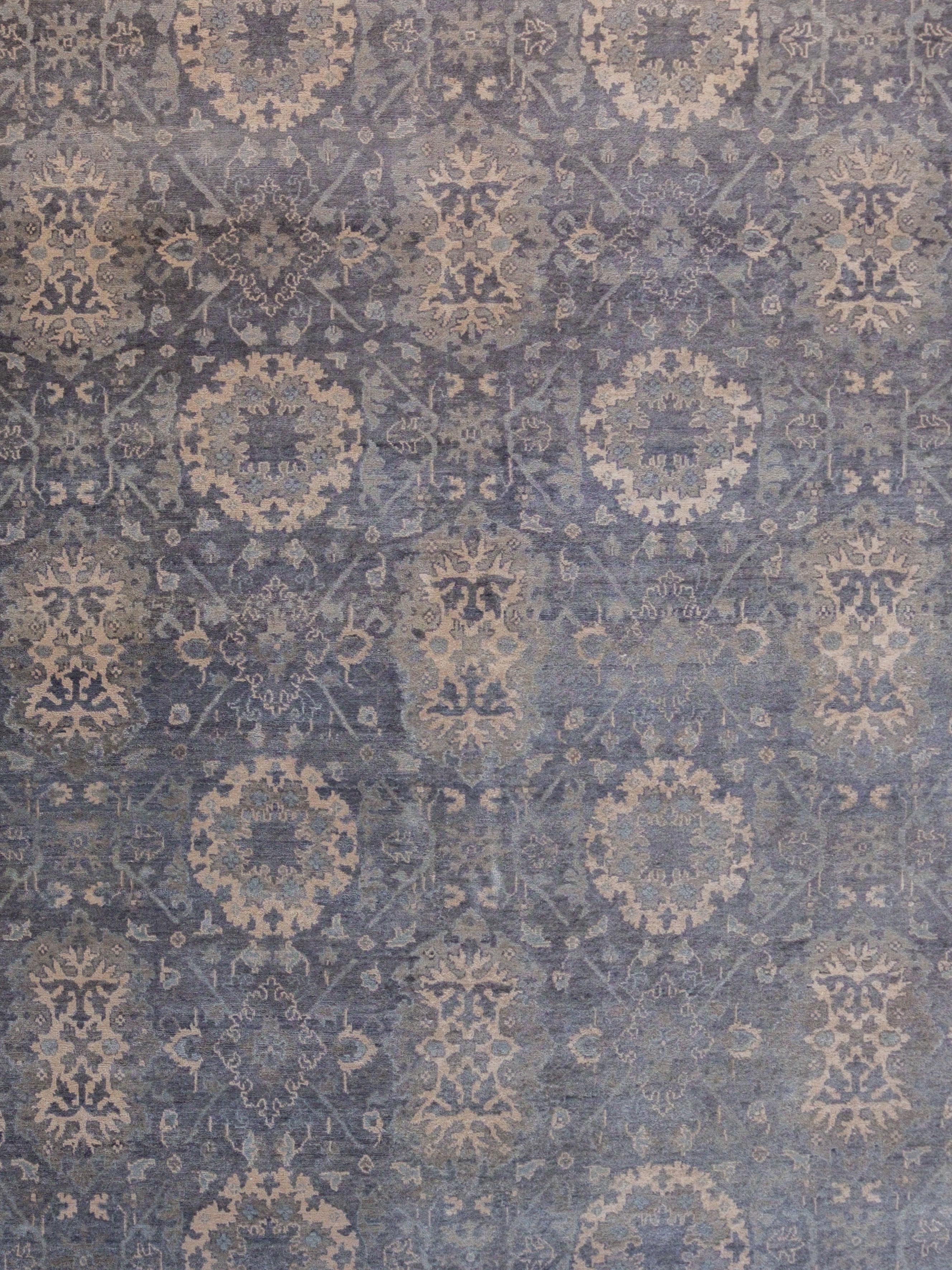 Adorned with interconnected floral motifs, this transitional wool carpet measures 8’10” x 11’11” and is hand-knotted using a traditional Persian weave. The carpet’s design depicts a blooming transitional flower garden, detailed with cream, gray, and