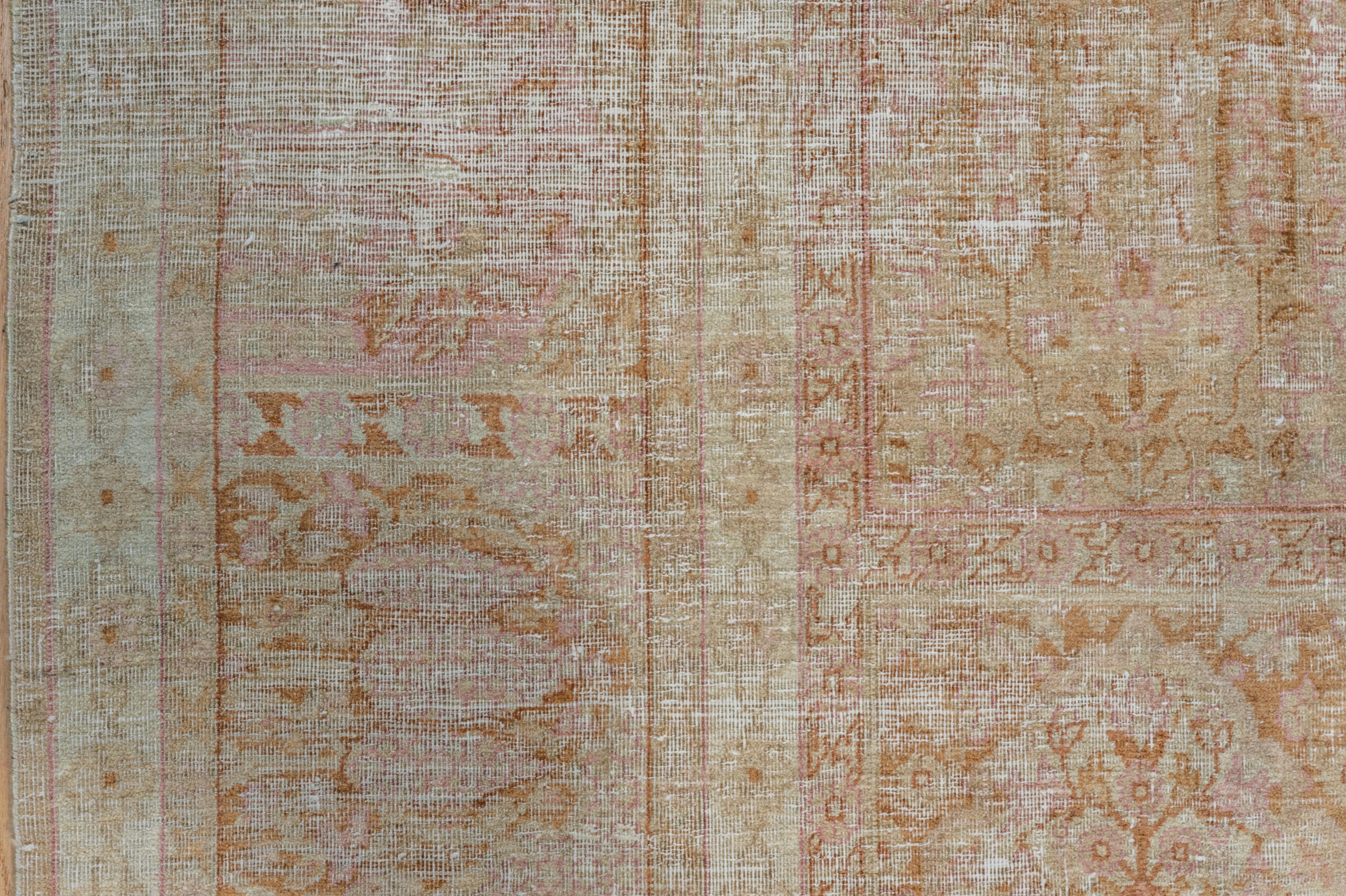 This eastern Turkish town carpet shows a repeating panel pattern of niches with cypresses, , flowers and vases in a restrained palette featuring cream, pearl, light brown rust and pink.