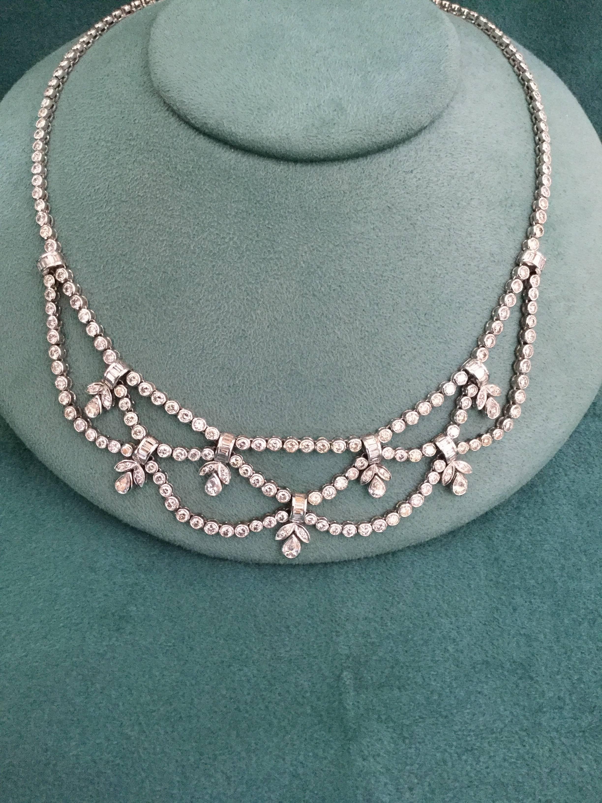 18K white gold necklace containing round, pear shape and baguette diamonds
Approximately 18.50  carats of diamonds. The necklace weighs 45 grams.