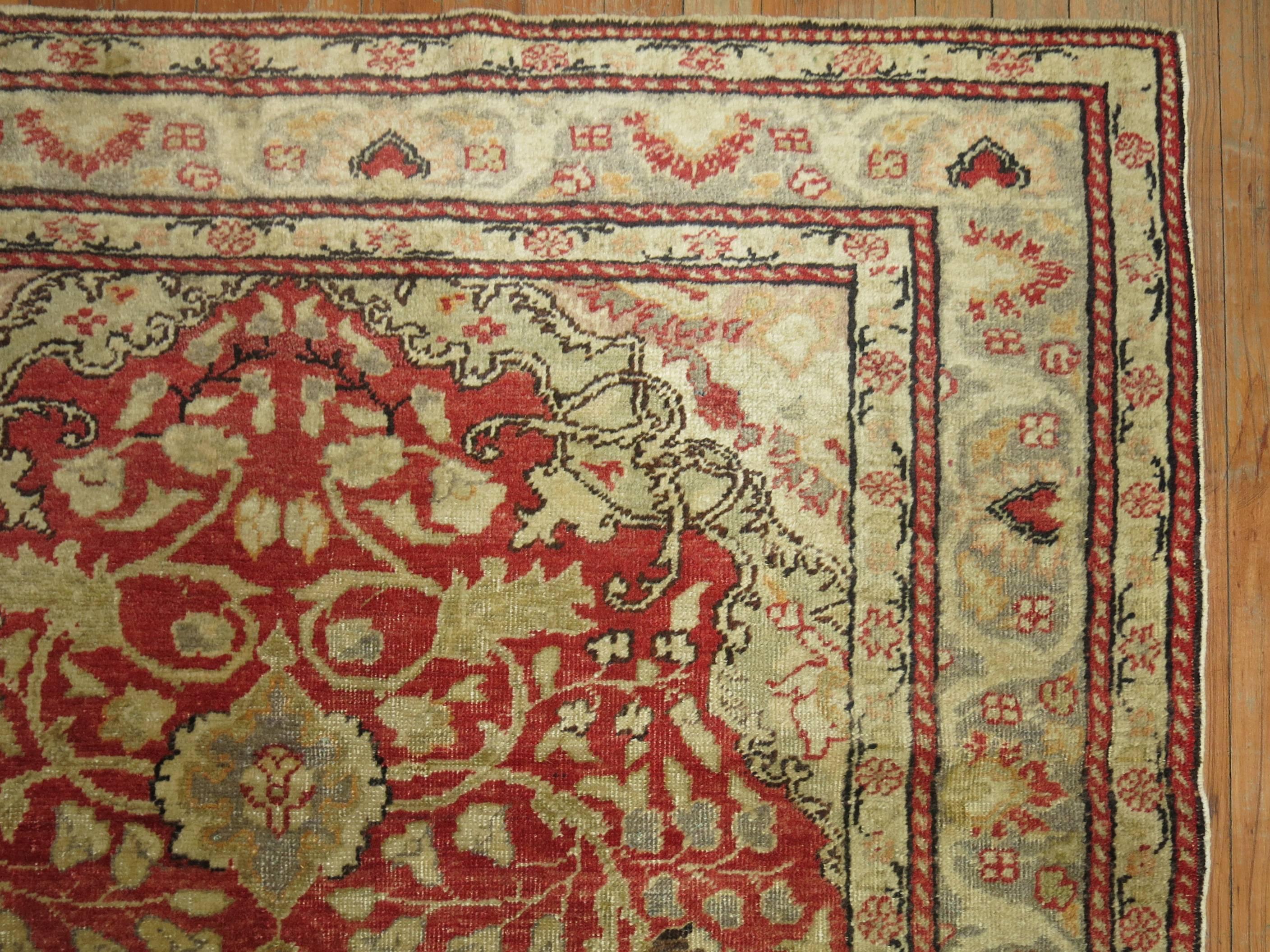 Accent size Turkish Oushak rug in predominant true red tones.