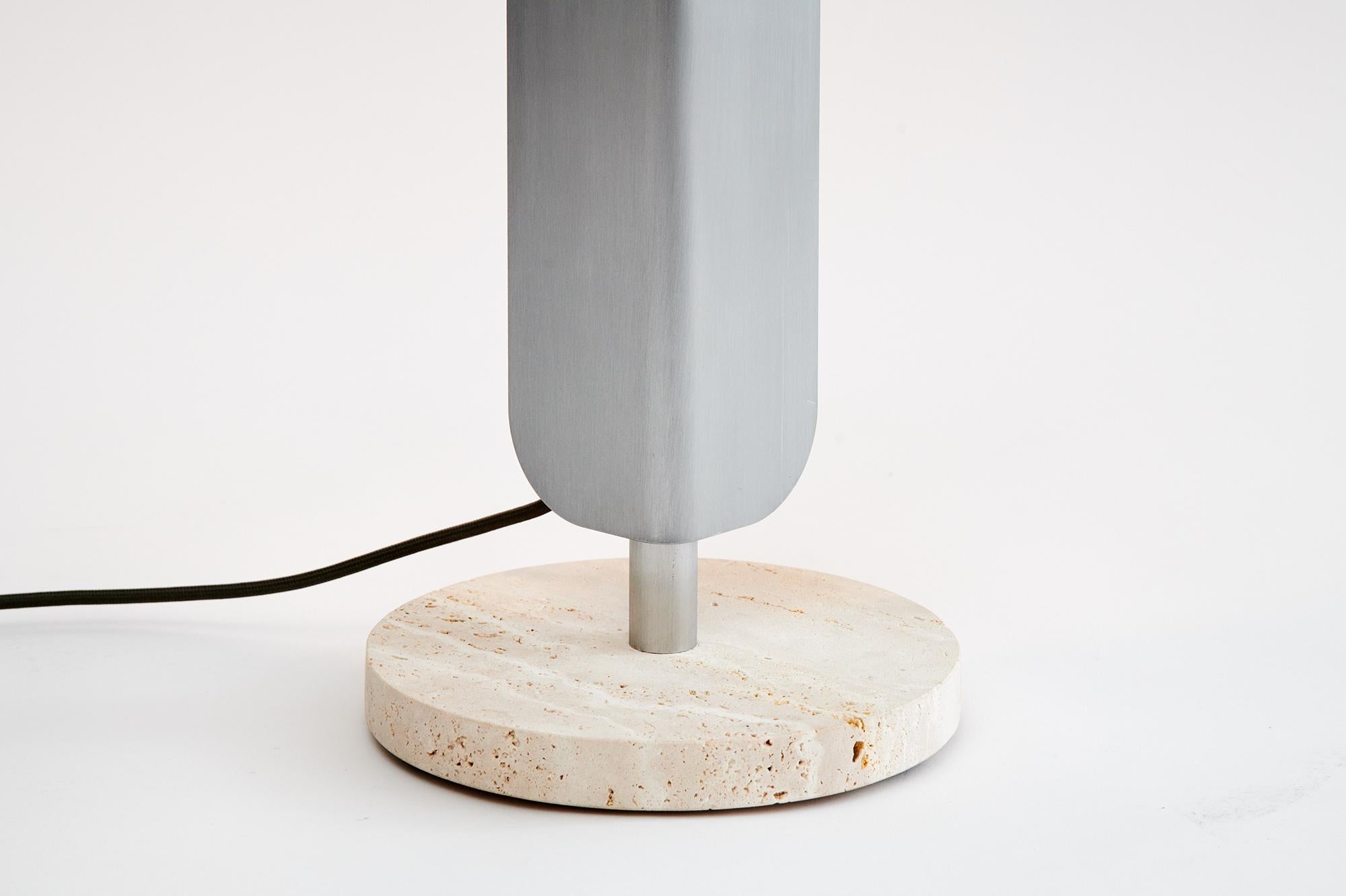 A freestanding, dimmable LED light source. Designed to cast light onto a wall, infusing any space with a warm ambience.
Two editions of the formation floor lamp are available. The first matches a grey marble base with anodised ‘Deep Sea’ aluminium.