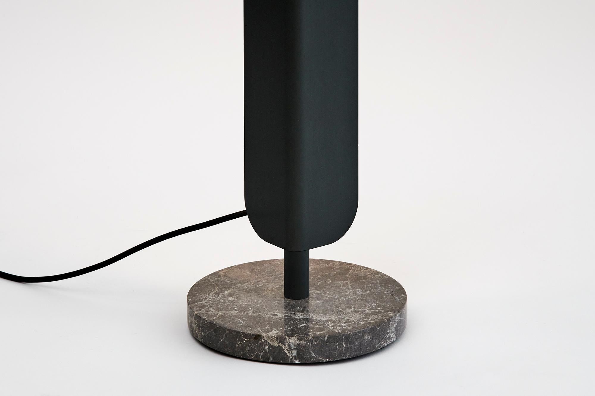 A freestanding, dimmable LED light source. Designed to cast light onto a wall, infusing any space with a warm ambience.
Two editions of the Formation Floor Lamp are available. The first matches a grey marble base with anodised ‘Deep Sea’ aluminium.