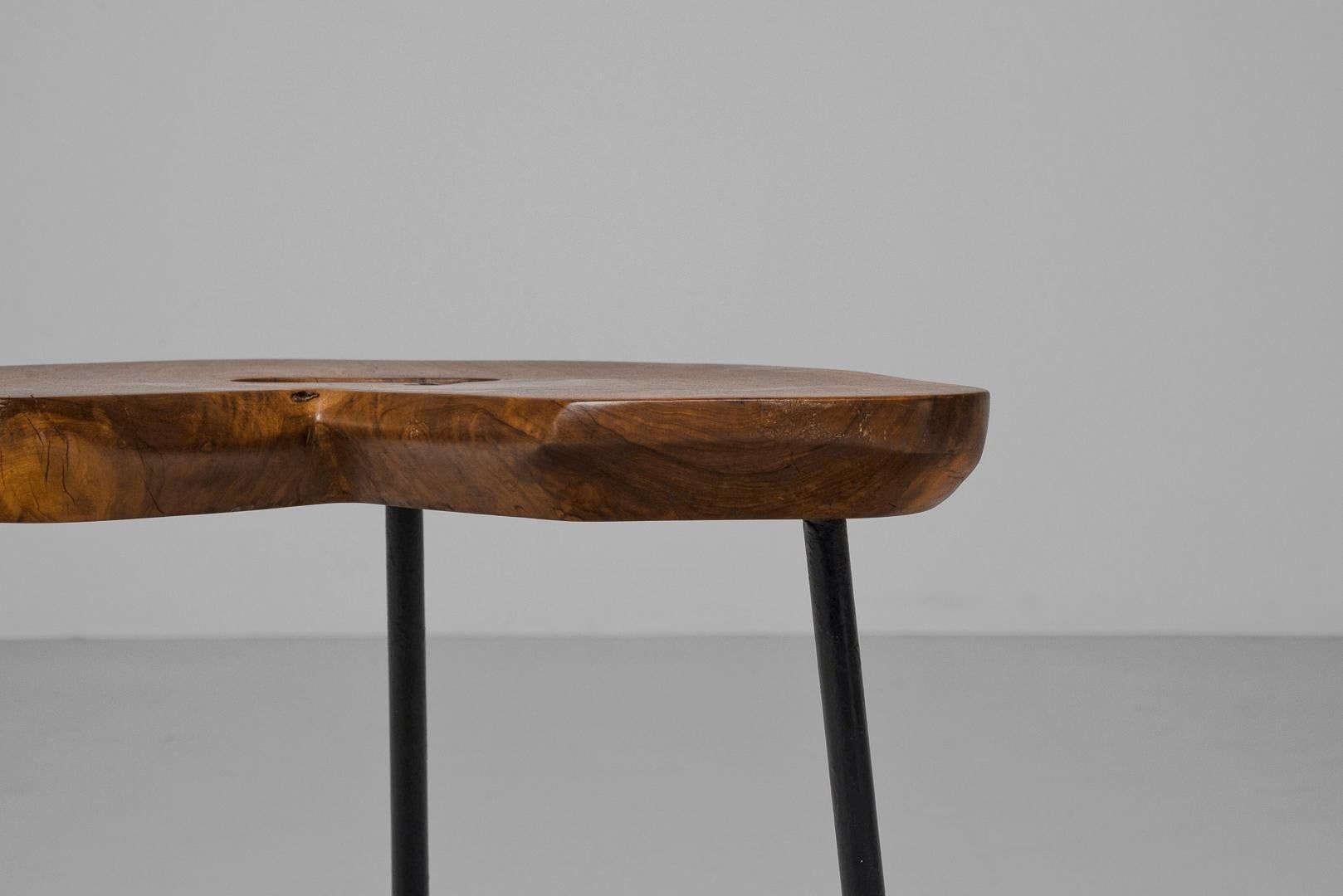 Beuatiful Forme libre stool in elmwood made in France in 1950. A gorgeous wooden seat inspired by Carl Aubock. It's made of solid elm wood with a beautiful grain pattern. The legs are strong steel, painted black for a modern touch. A great feature
