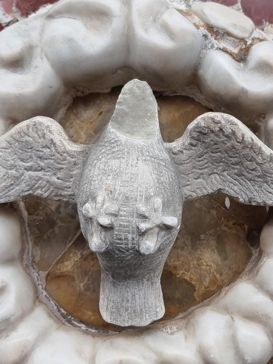 Rectangular tile carved from white Carrara marble with inserts of red marble from France, probably made in the Veneto area during the 17th century. In the center of the composition is the figure of the Holy Spirit's dove, carved in relief in marble,