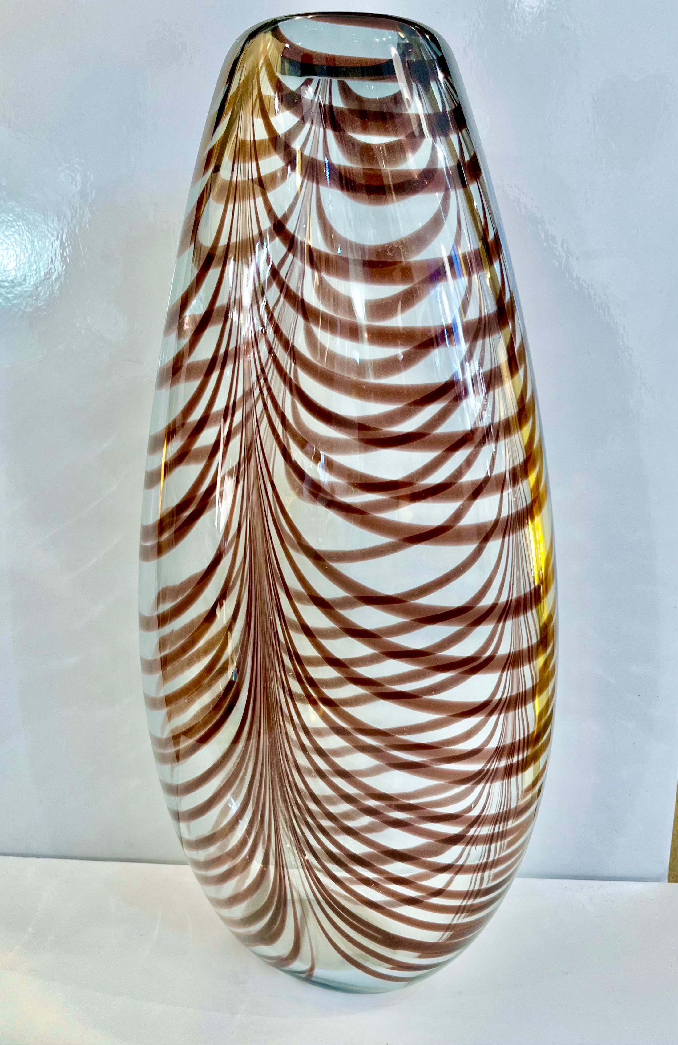 Precious vintage art sculpture vase by Formia in overlaid blown crystal clear Murano glass with organic Fenicio decoration in an unusual deep amethyst color. This heated decor technique consists in applying vitreous threads of Murano glass to the
