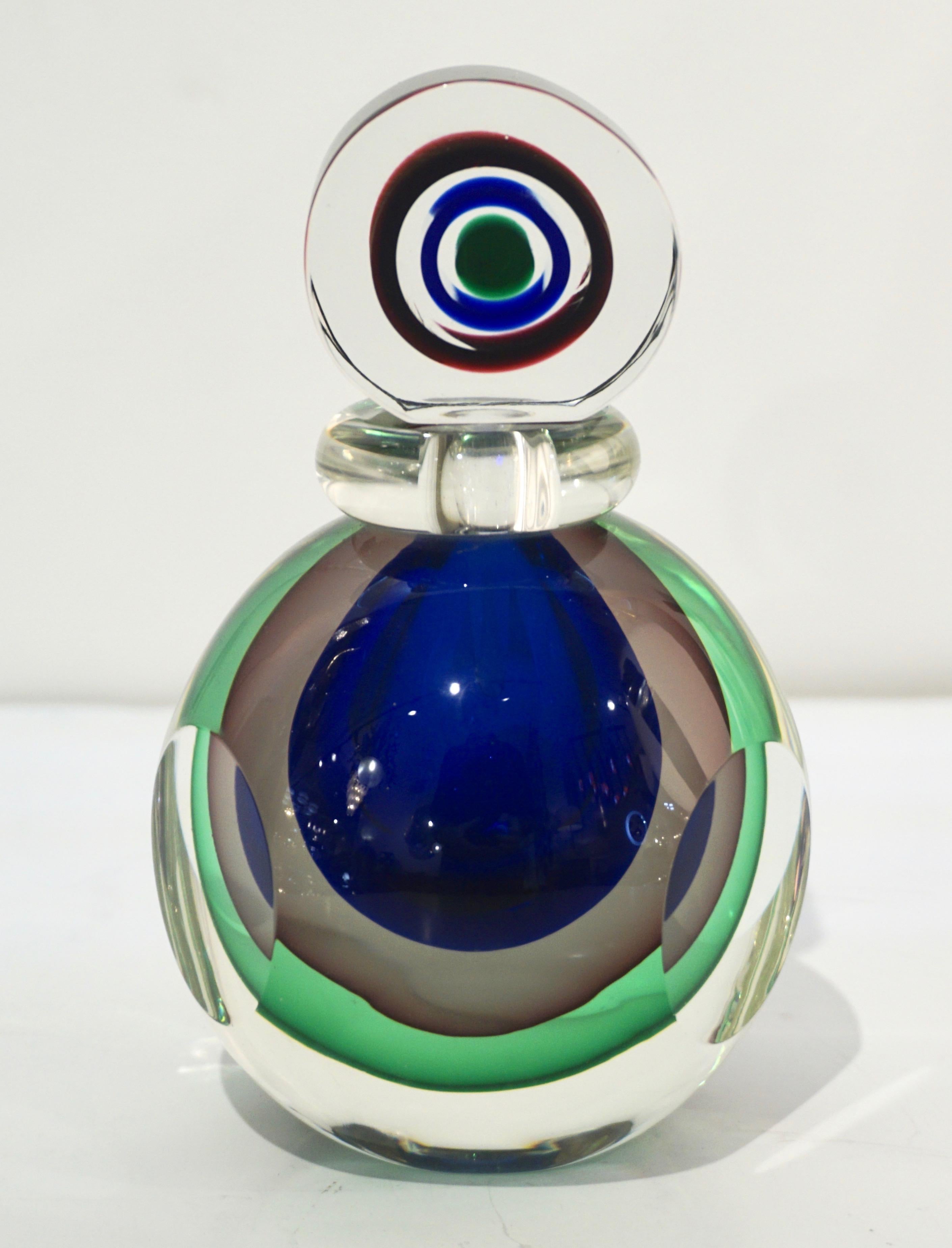 A vintage Murano glass perfume bottle of an interesting organic round shape with 3 flat decorative sides and unusual candy flat drop stopper, the body and the stopper each worked with the Venetian technique Sommerso: the 3 colors, green, royal blue