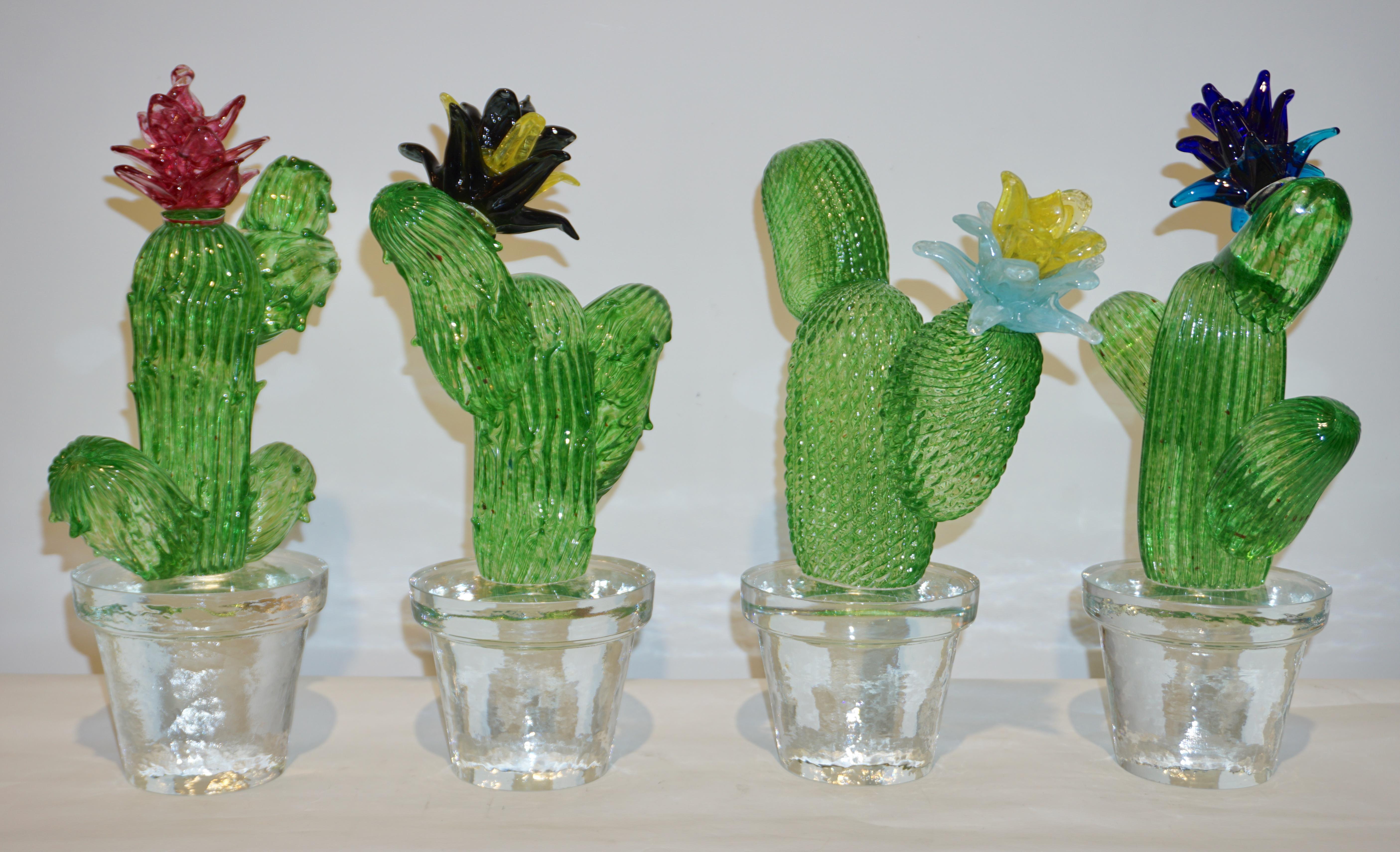 1990 Italian highly collectible cactus of limited edition, modern design by Marta Marzotto, realized by Formia, in a lifelike organic shape in verdant light emerald green with a black and yellow flower, planted in a crystal clear Murano Glass