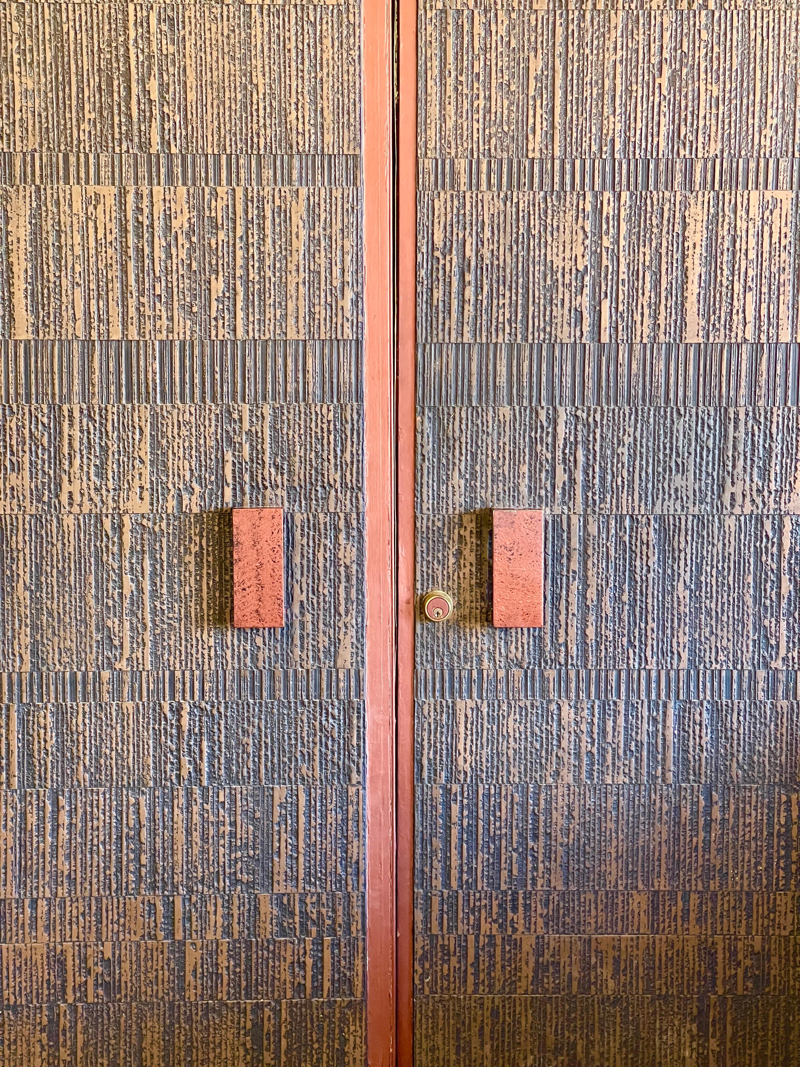Great set of Bonded Bronze Brutalist doors by Forms and Surfaces. These doors have a wonderful patina. In a wood frame. These doors were custom ordered from the estate and are unusually sized at 83 inches wide. They are 94 inches tall. The wood