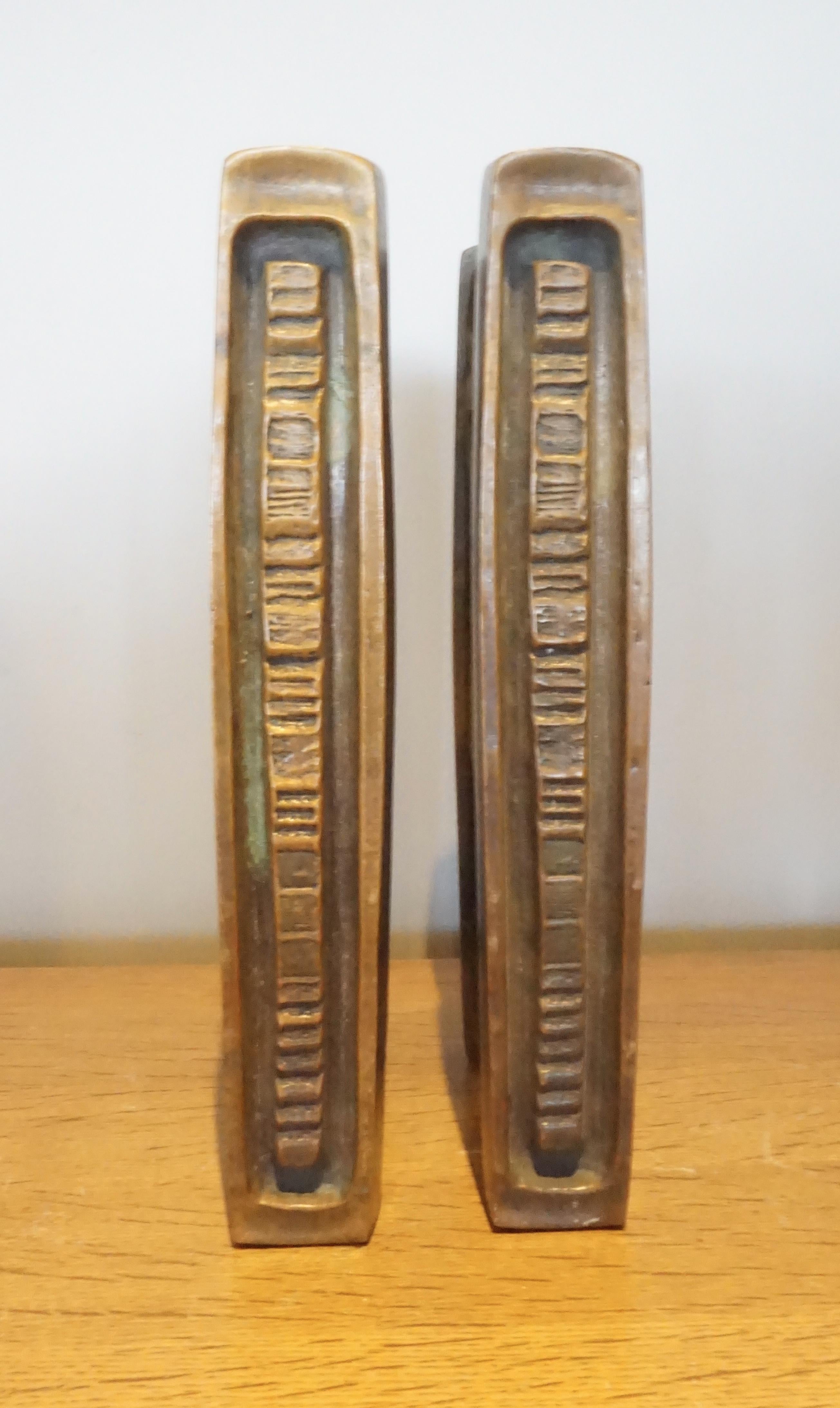 A pair of two-sided Mid-Century Modern solid bronze door handles made by the American hardware company Forms and Surfaces in the 1960s. These cast bronze pulls were created for double entry doors and are over-sized, extremely heavy and of superior