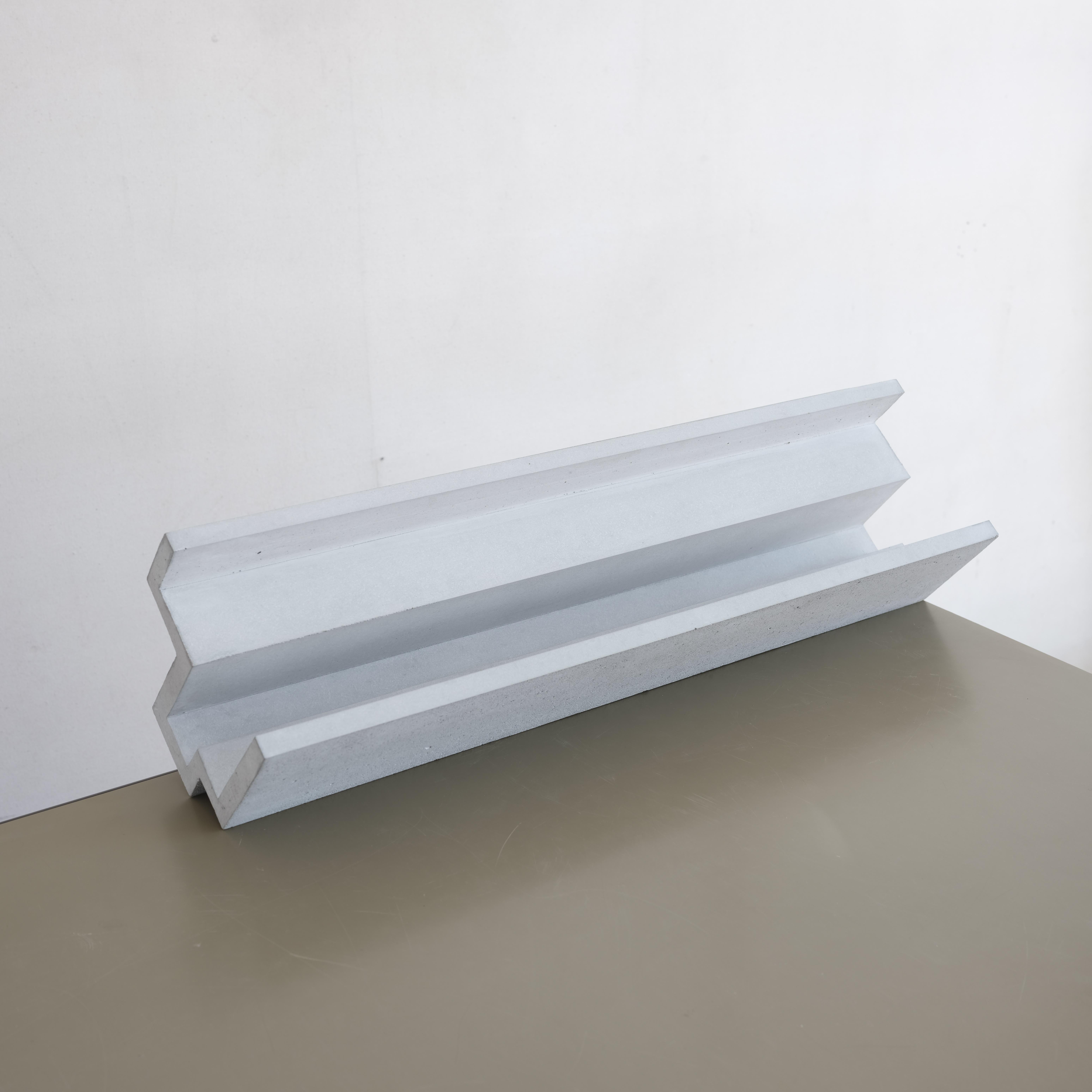 Handcrafted geometric concrete sculpture Formworks 7 by Spanish designer Manolo Menéndez. It can serve as a centerpiece, a fruit bowl, or simply as a striking minimalist artwork.
It is part of a collection of ten sculptural pieces conceived in a