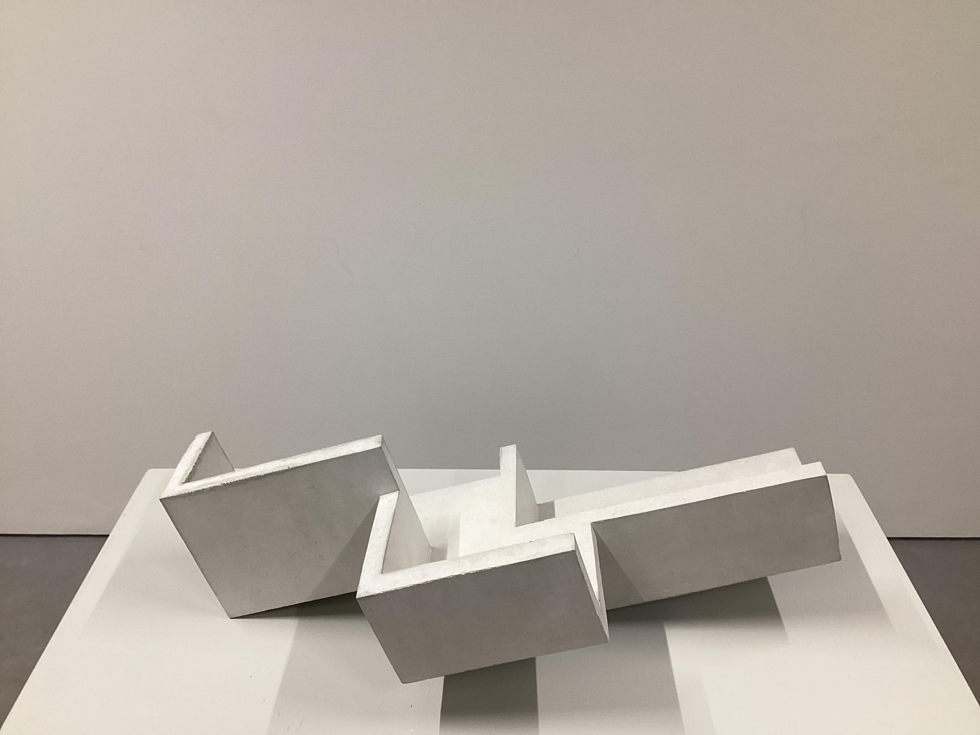 Handcrafted geometrical concrete sculpture Formworks #6 by Spanish designer Manolo Menéndez. It can be used as a centerpiece and book and magazine holder. 
A collection of 10 sculptural pieces designed in a minimalist architectural language that