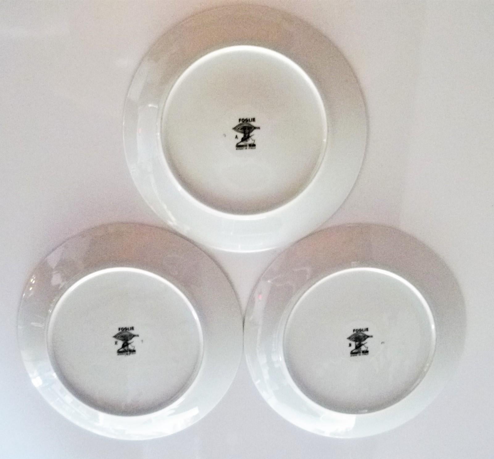 REDUCED FROM $900....Set of three black and white porcelain Foglie or Foilage plates by Piero Fornasetti for Fornasetti Atelier in Milan from the 1950s. Each depicting beautifully three different leaves. The two plates with the larger black leaves,