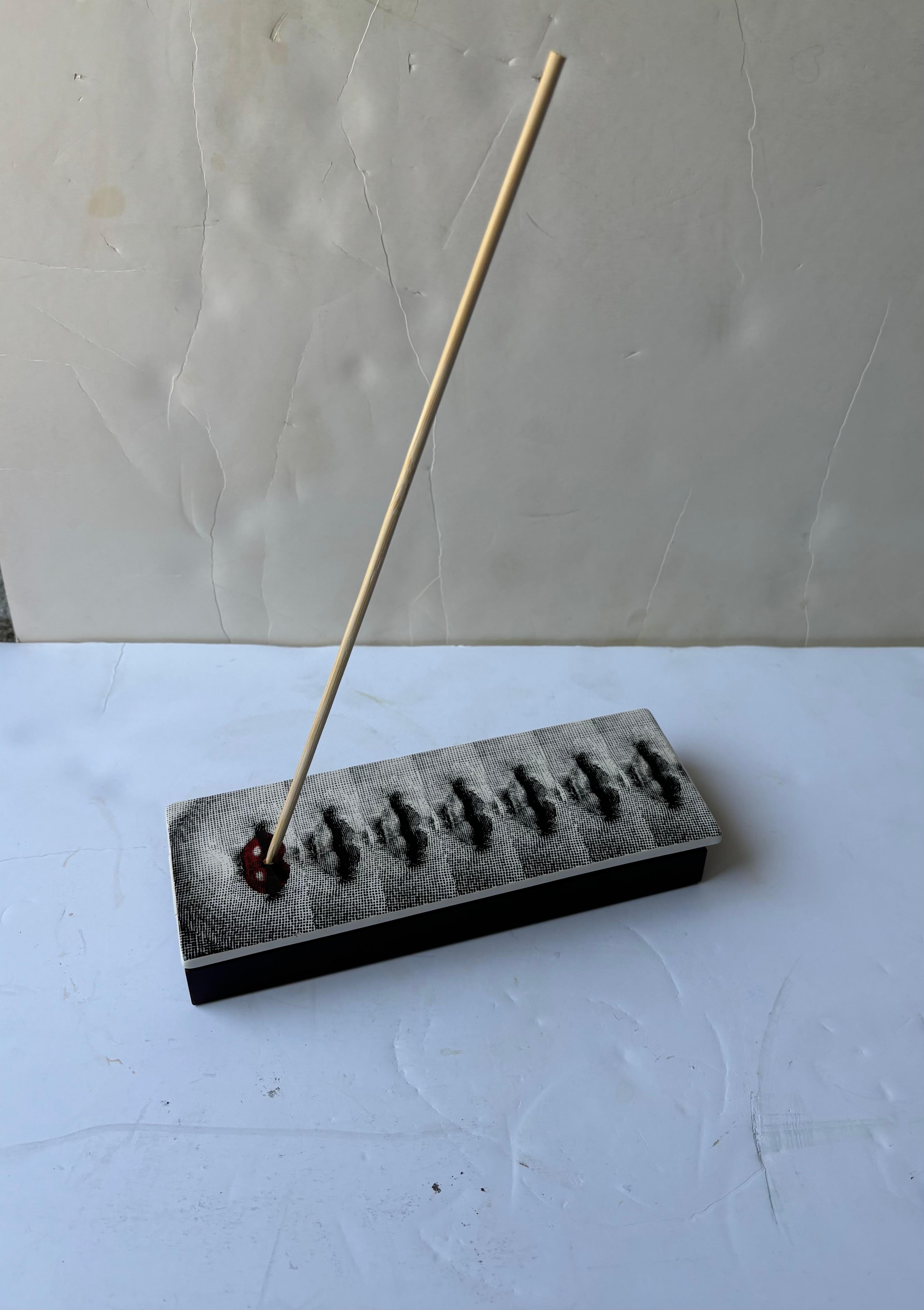 Nice and surrealist style in this traditional design by the well known artist / designer Piero Fornasetti . This box is also for incense and has a hole for burning . Not incense included . Just Box 