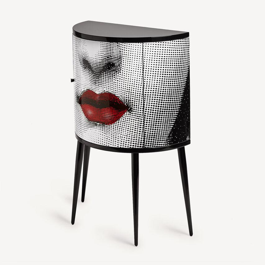 The Fornasetti console is a wooden storage piece of furniture silkscreened and laquered by hand following the Atelier's traditional method.

Like each Fornasetti wooden piece of furniture, it is silkscreened and lacquered by hand and any minor