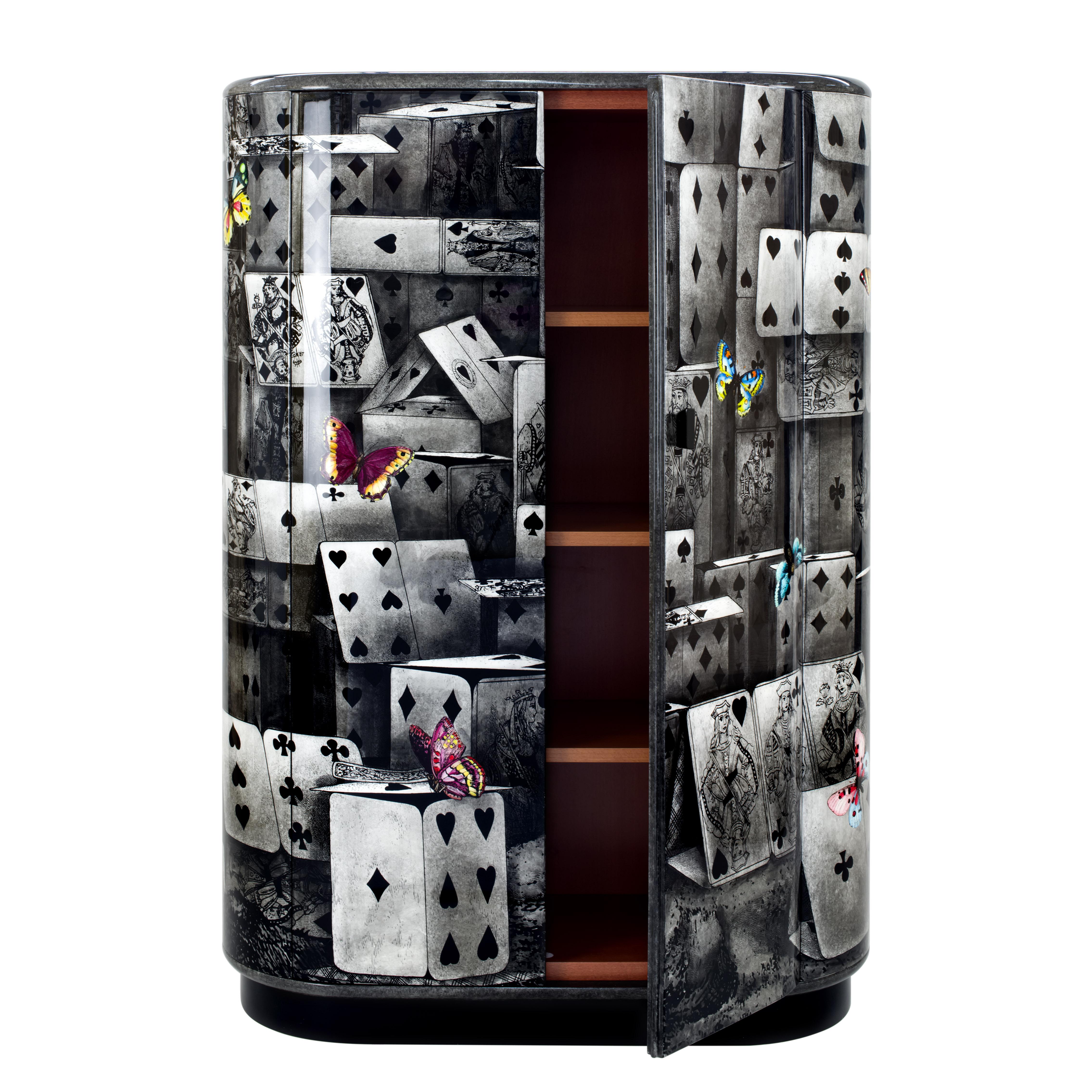 The curved cabinet shape was designed by Barnaba Fornasetti in 2003 and now it can be considered one of the most iconic pieces of furniture in the Italian atelier's collection. 

Like all Fornasetti pieces of furniture, it is handcrafted using