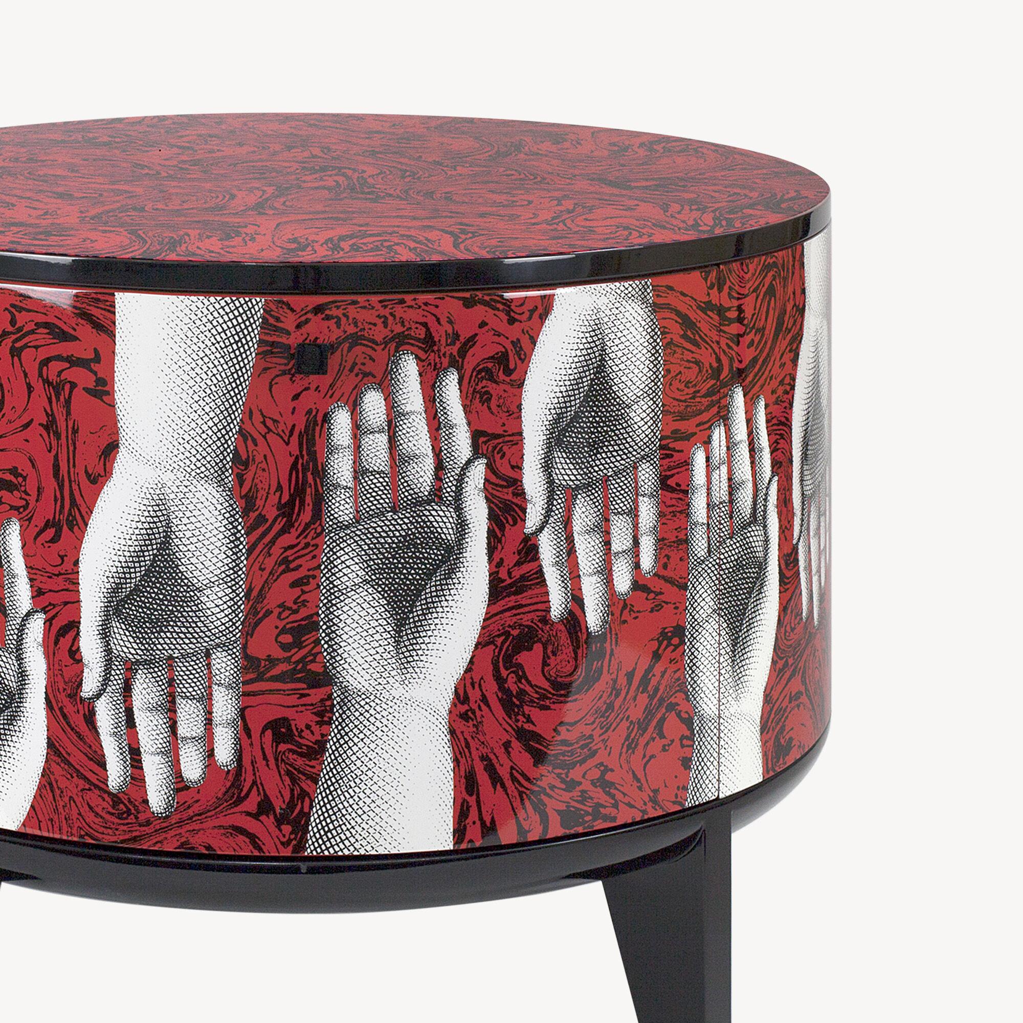 The Fornasetti Tamburo is a wooden storage piece of furniture. its versatile shape turns it into a table. the wood is silkscreened and laquered by hand following the Atelier's traditional method.

The decoration is Fornasetti's tribute to Mozart's
