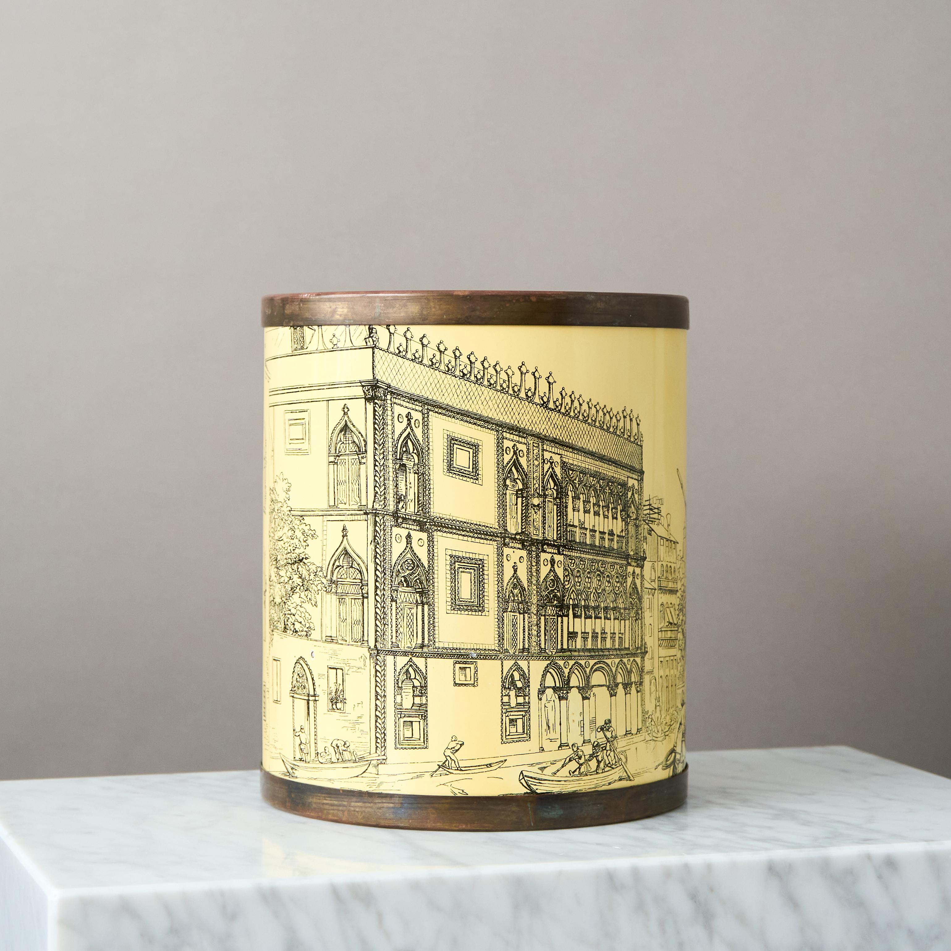 Italian 1950’s midcentury wastebasket by Bucciarelli of Milan with brass rim and graphic print on an ivory enamelled surface. 

This piece was most likely one of a number of designs by Fornasetti commisioned by the Milanese department store