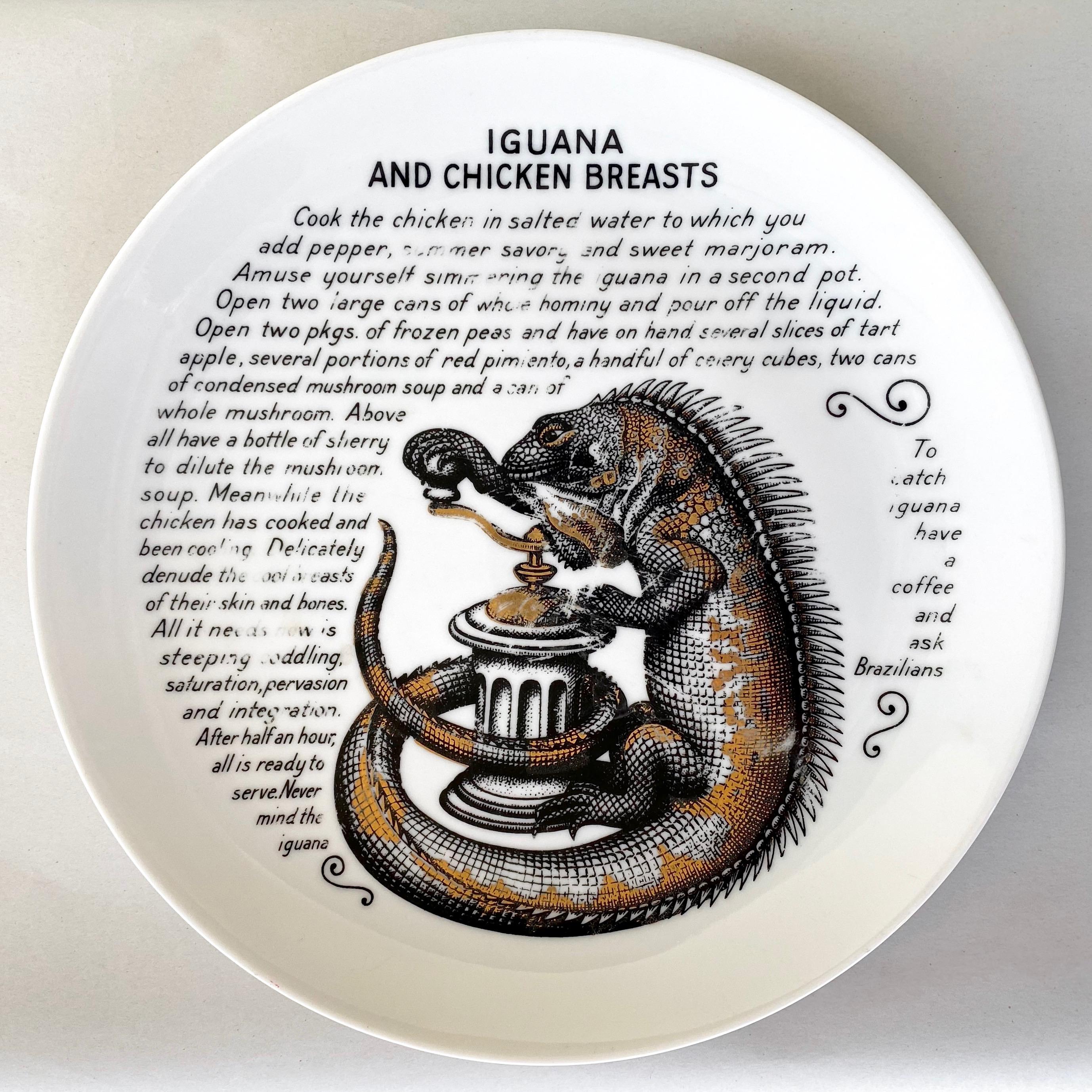 A rare 1960s Piero Fornasetti for Fleming Joffe Ltd. “Iguana and Chicken Breasts” recipe hand-decorated and gilt porcelain “Cook Plate”.

Wonderfully wry recipe for an absurdly improbable dish surrounds the surreal image of a pepper mill-cranking