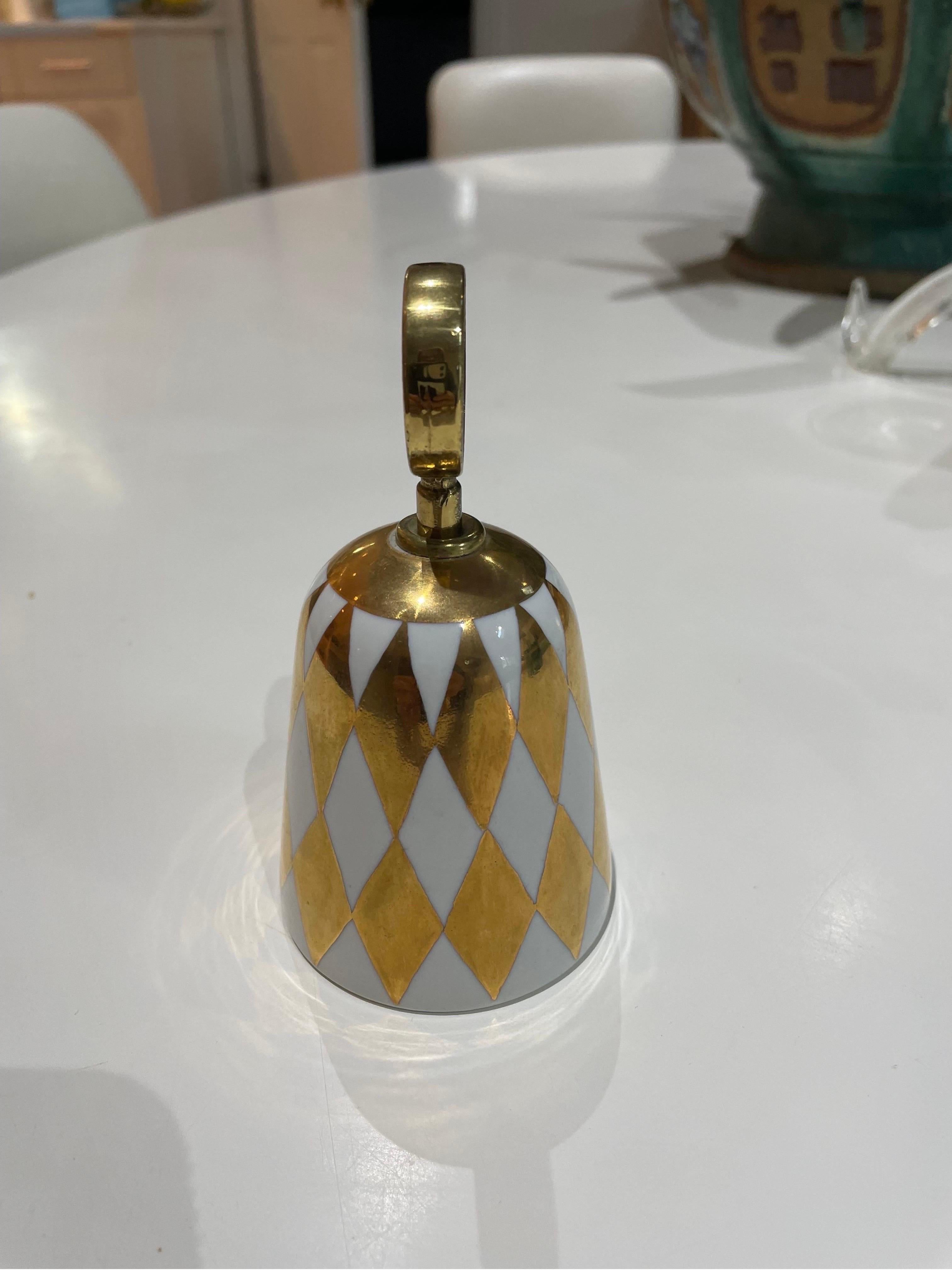 This is a unique and rare fornasetti gold and white porcelain bell from Italy.