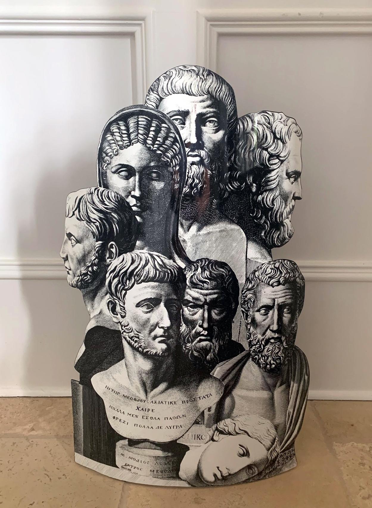 A metal umbrella stand by Italian design firm Fornasetti, known for its eye-catching and often whimsical graphic design and transfer techniques to different surface. This figural 