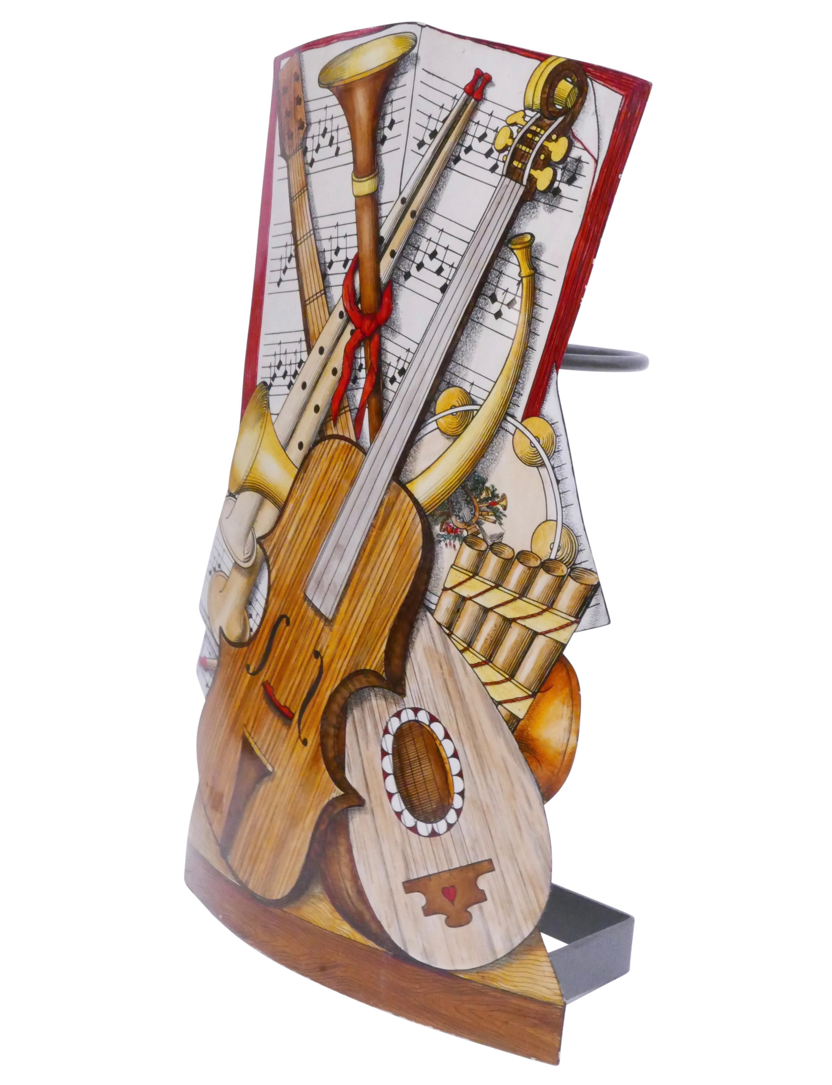 A Piero Fornasetti painted metal umbrella stand of a musical theme with painted sheet music and musical instruments. Original label on the reverse.
Italy, circa 1980s.