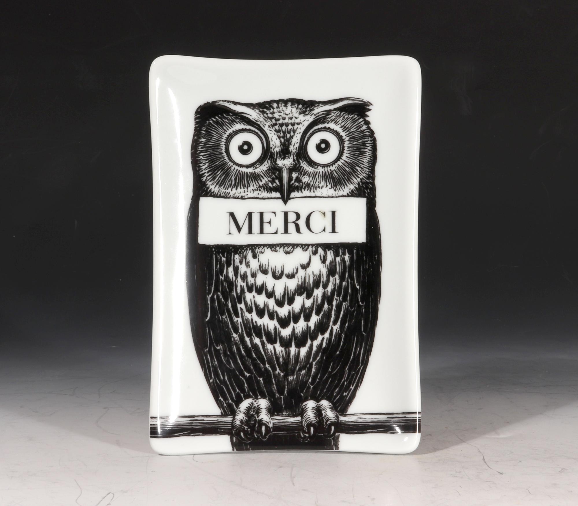 Fornasetti owl small ceramic tray,
With Original Box,
Atelier Fornasetti,

The rectangular Fornasetti ceramic tray depicts an owl perched on a tree branch in black and white while holding a rectangular banner reading 