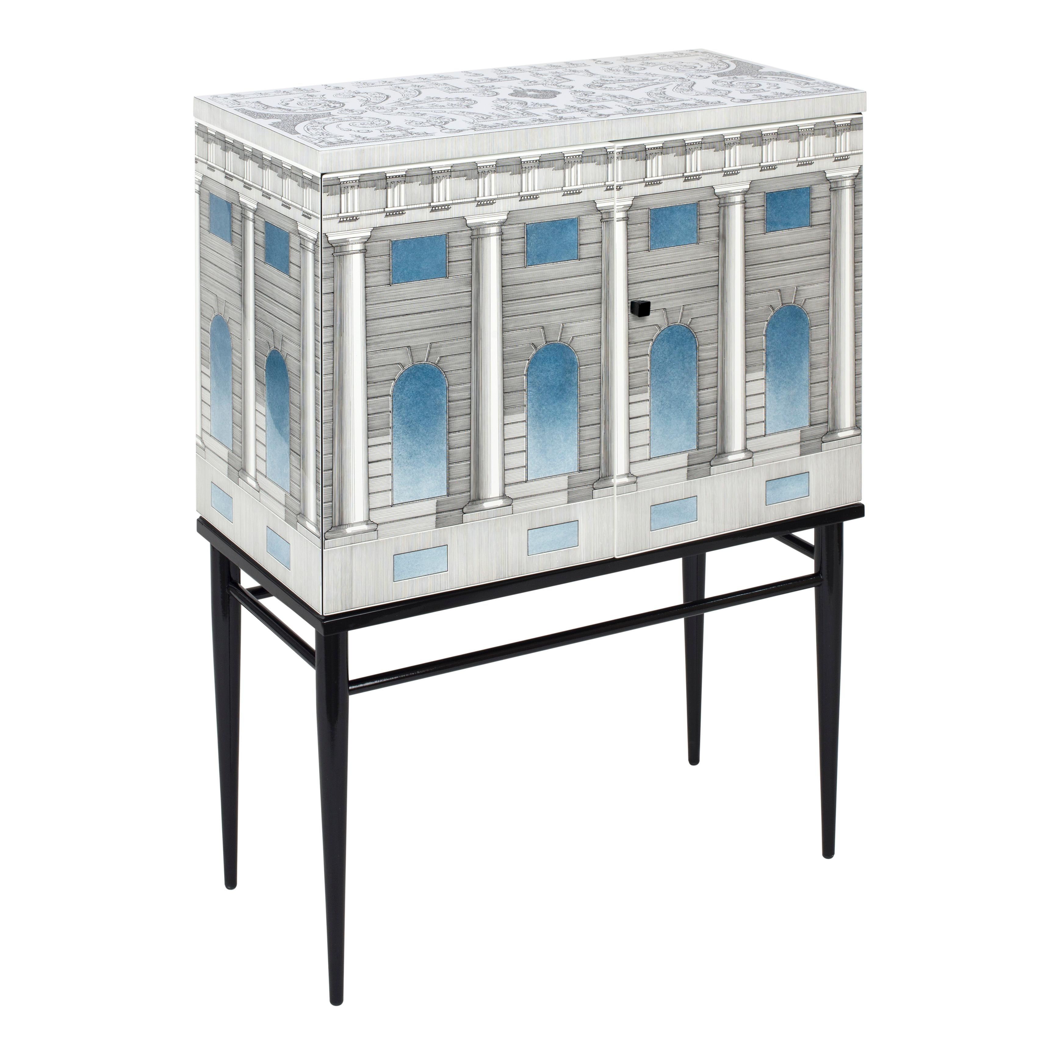 The sideboard cabinet is handcrafted using original artisan techniques, like all Fornasetti pieces of furniture
This cabinet is silk-screened by hand, hand-finished and covered with a smooth lacquer.

It is part of the Architettura Celeste