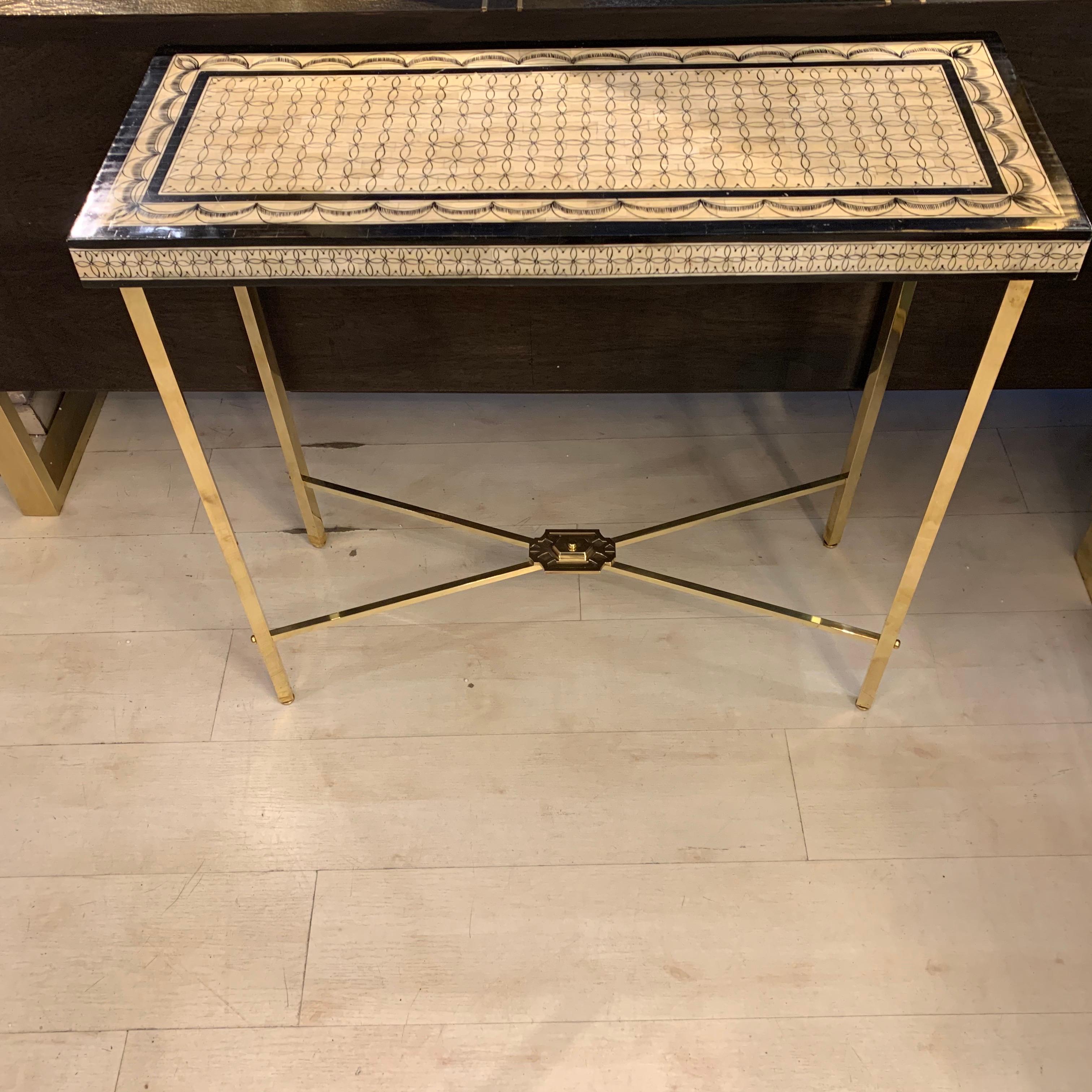 Fornasetti style bone mosaic console with brass legs.
The bone tiles mosaic is decored with black Indian ink.