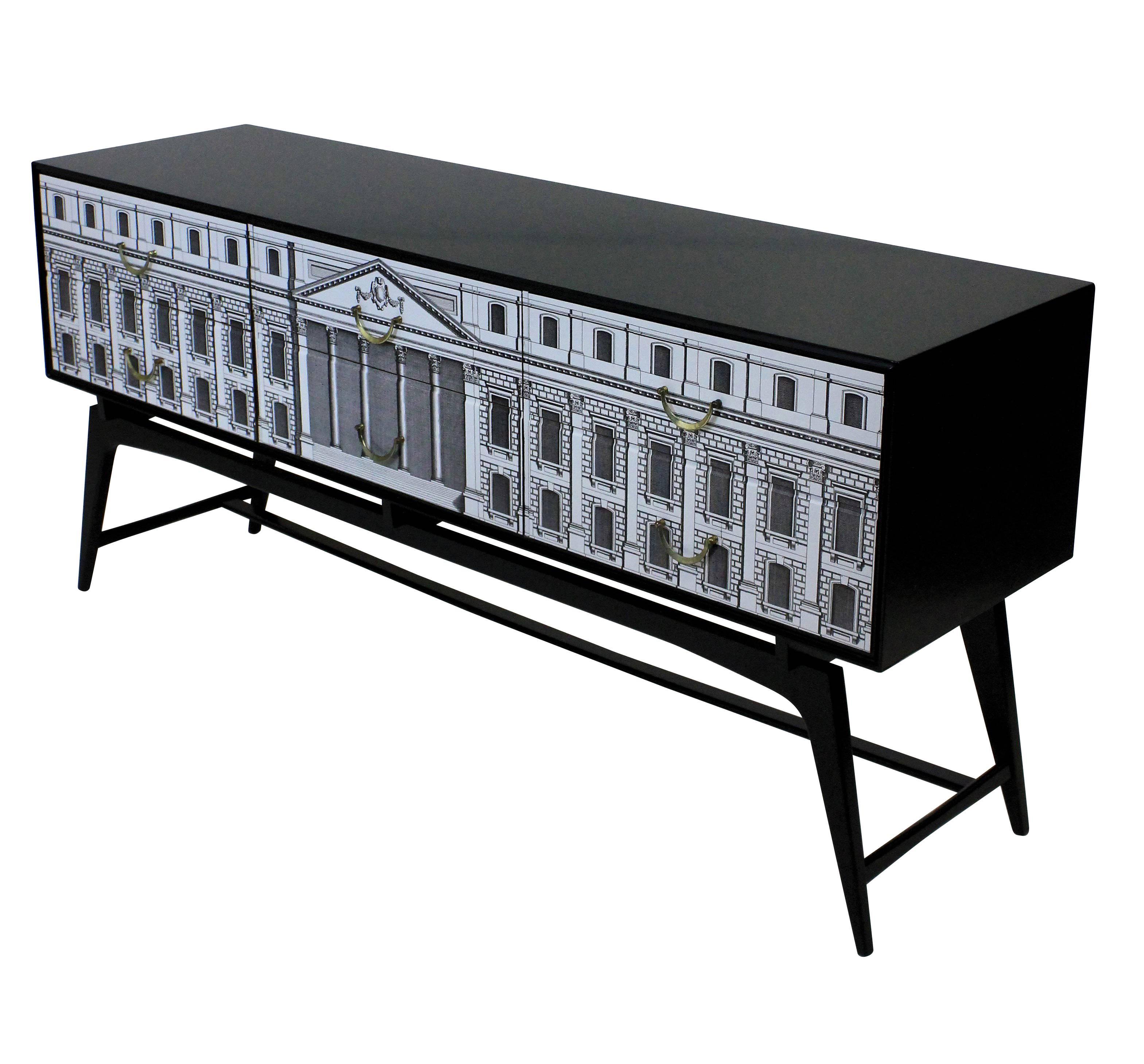 An English Fornasetti style credenza in black lacquer, with Neo-Classically inspired decoration. Six drawers with brass fittings.

        