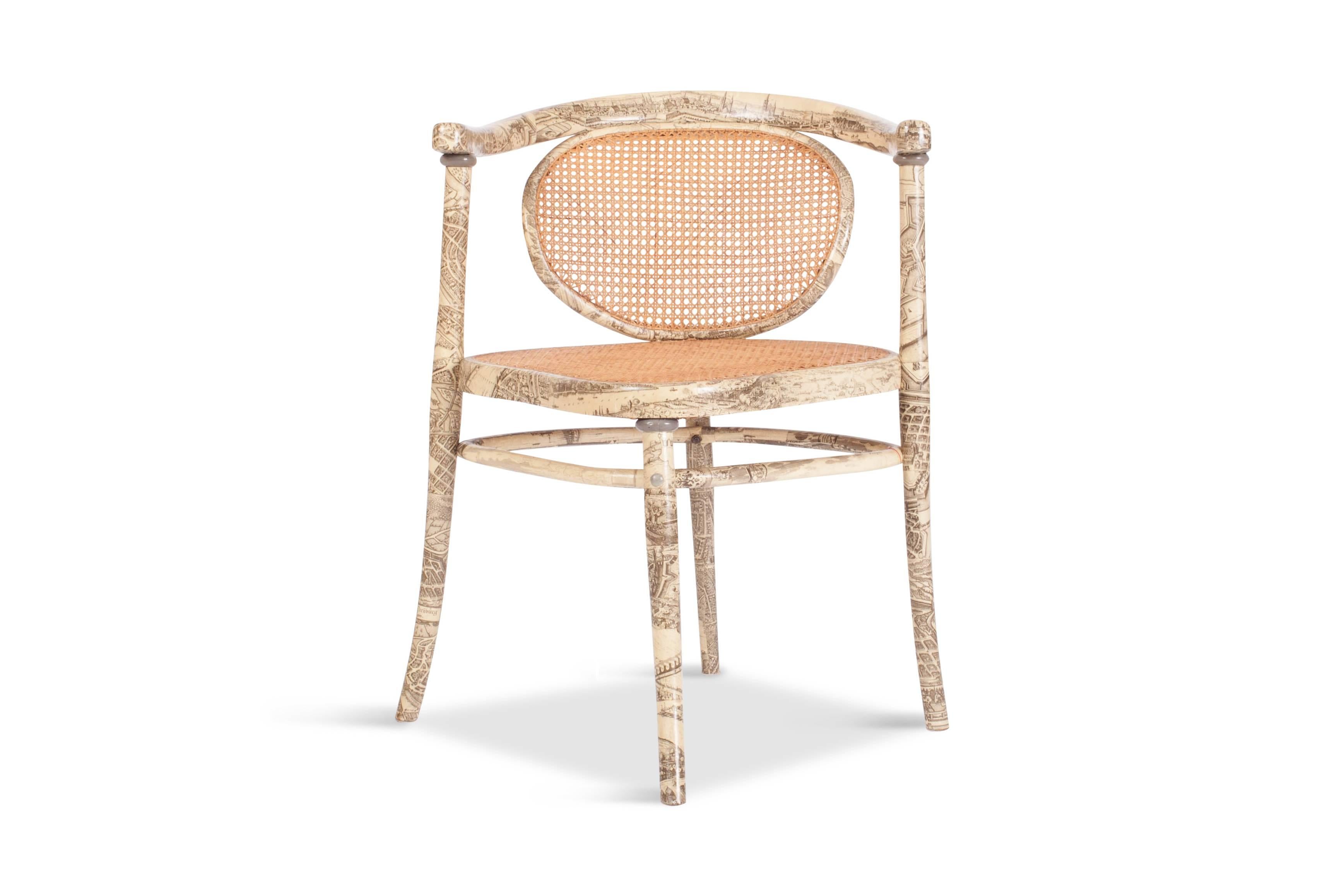 Striking asymmetrical chair by Thonet with saddle shaped seat.

The seat and backrest are weaved in rattan. The rest of the frame is covered in a print
that could have influenced by the great Fornasetti. The chair is marked on the inside of the