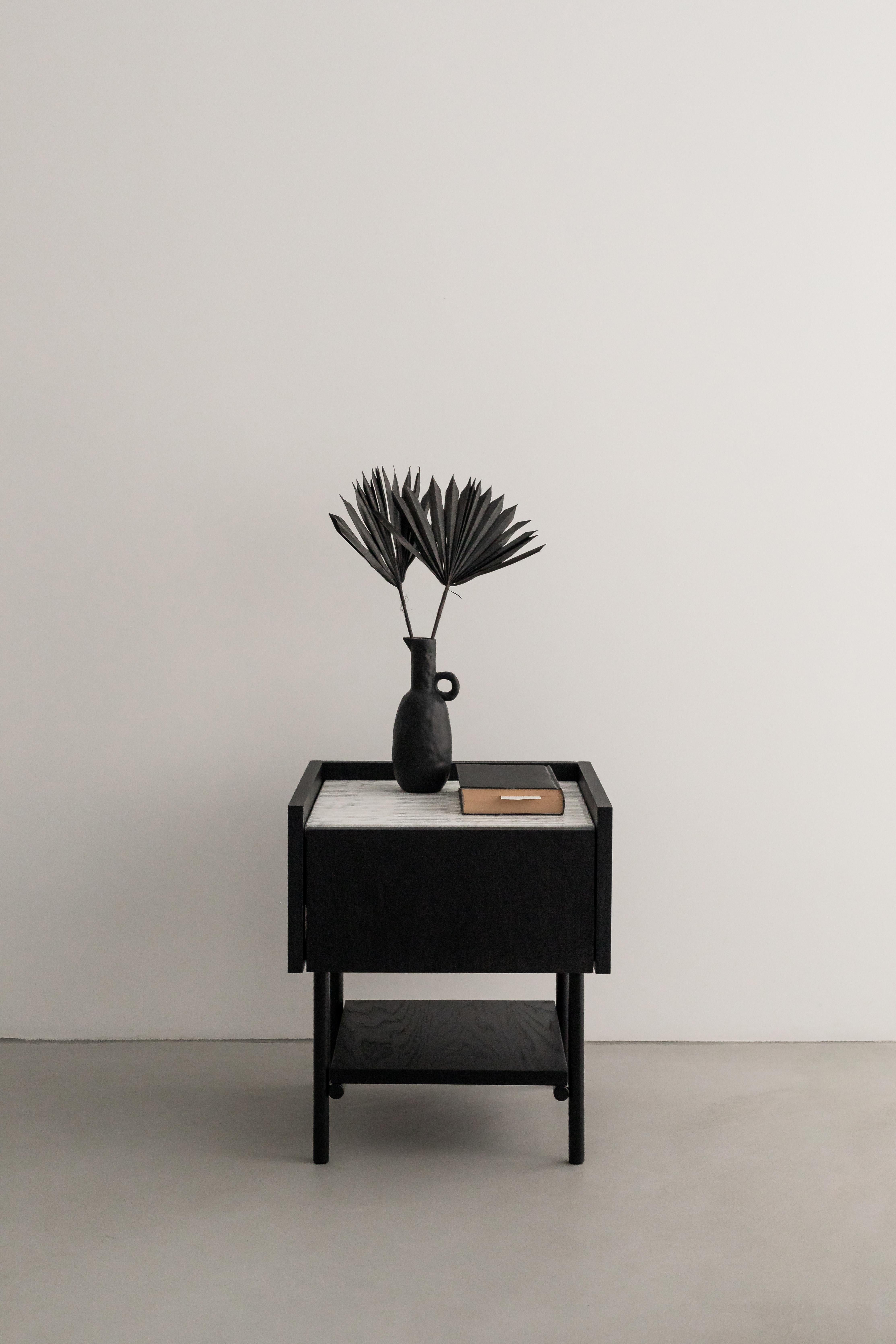 Forst Night Stand by Un’common
Designed by Małgorzata Korycka.
Dimensions: D 40 x W 40 x H 46 cm.
Materials: Graphite oak and Carrara marble.

Available in different finishes and materials. Please contact us.

FORST NIGHT STAND is an elegant bedside