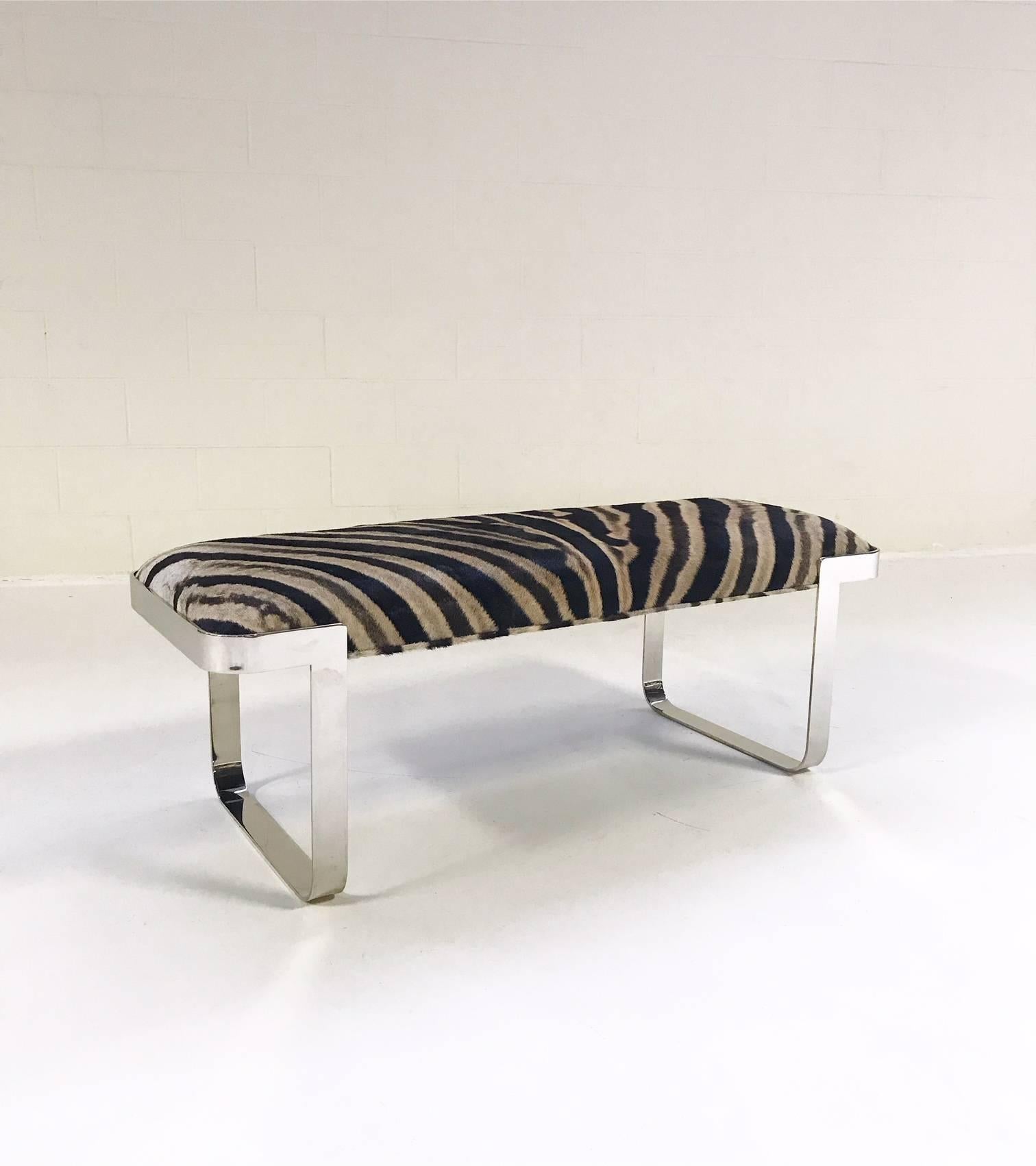 We keep picturing this amazing bench at the end of a beautiful bed. Our designers chose a zebra hide with undertones of slivery grey to pair perfectly with the slick and shiny chrome.

Measures: 49