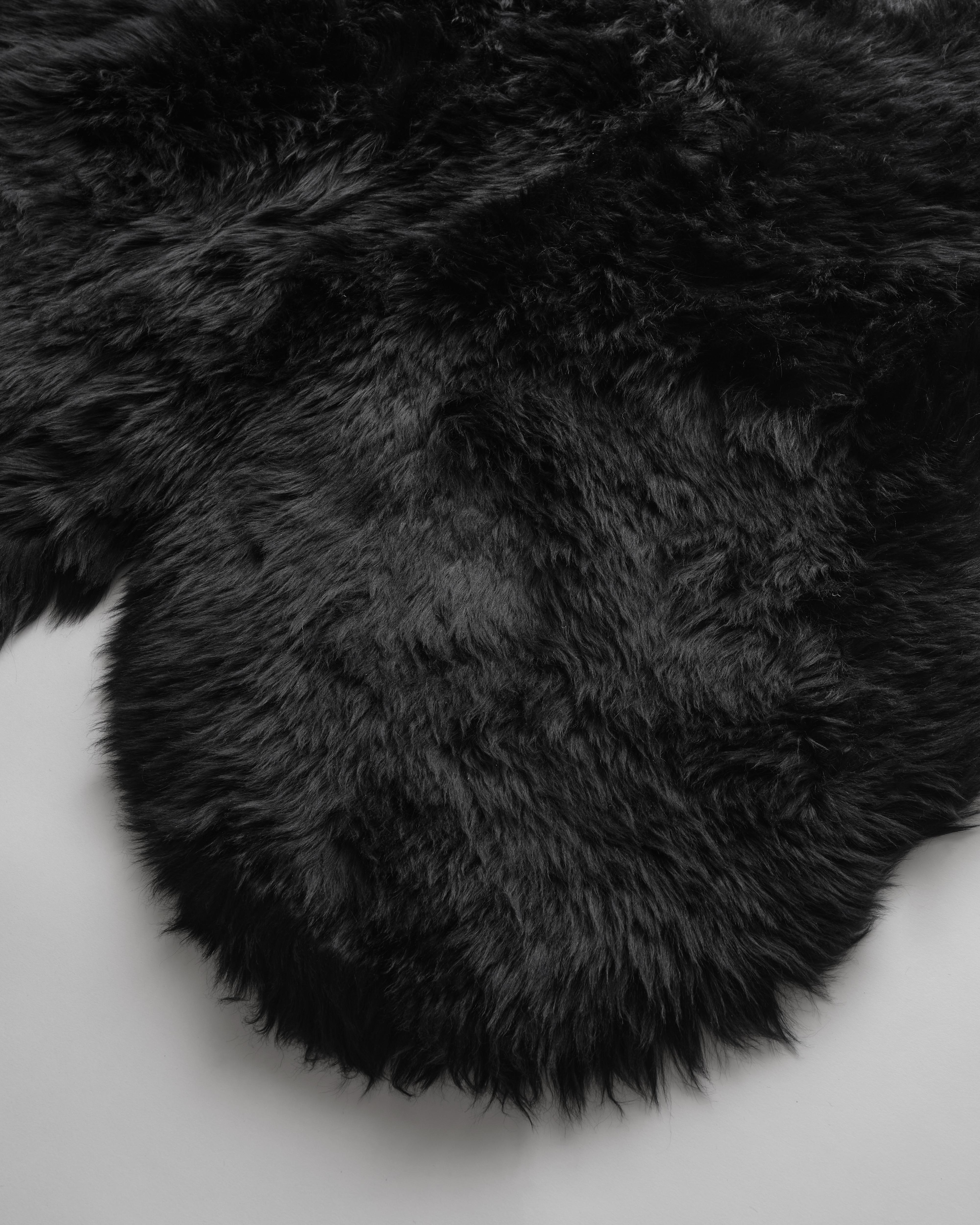 The naturalness and softness of a sheepskin rug can quickly elevate a room's beauty. On the floor, thrown over chairs and couches, this versatile design piece is a favorite of the Forsyth design team. 

This thick and beautiful sheepskin, dyed a