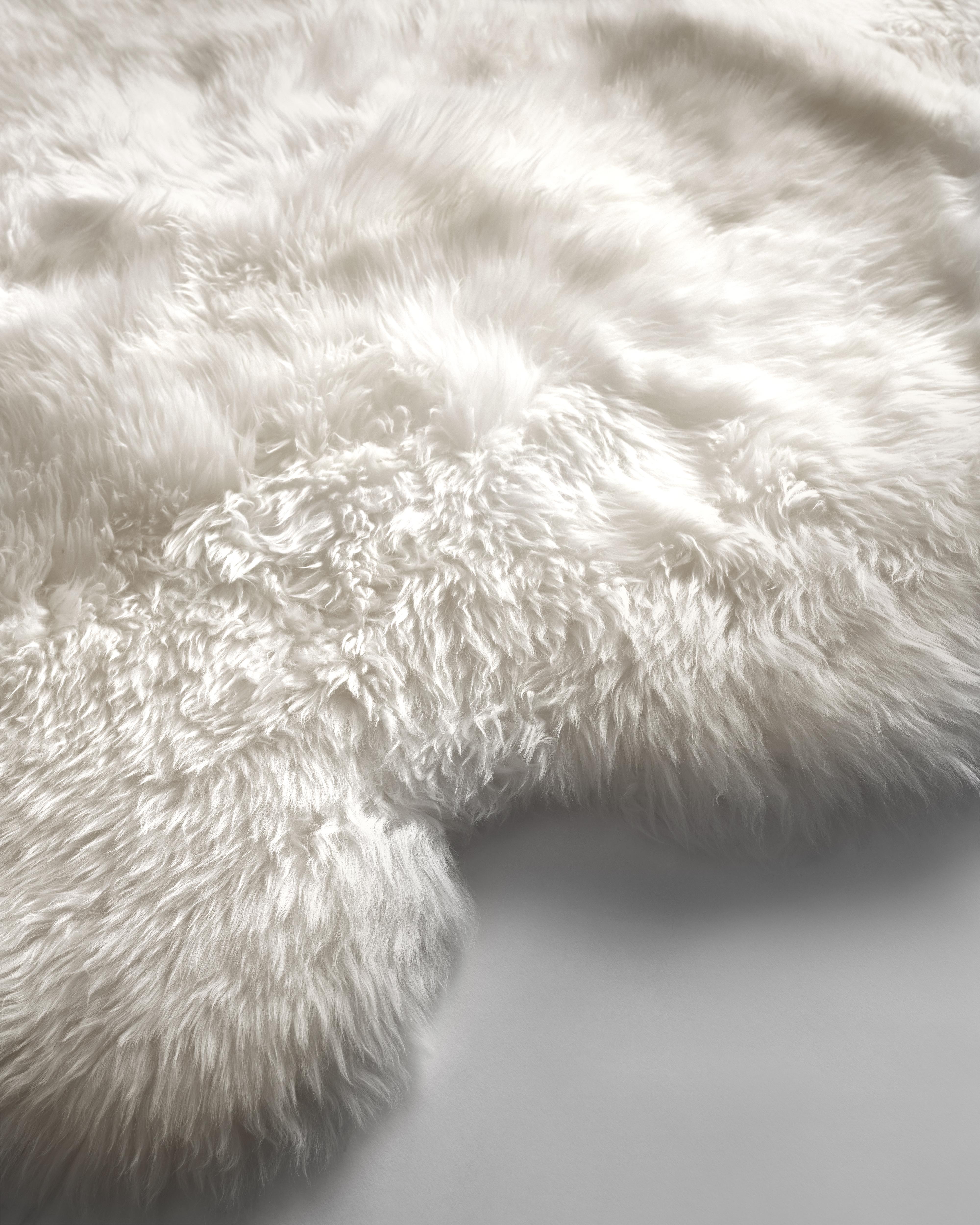 The naturalness and softness of a sheepskin rug can quickly elevate a room's beauty. On the floor, thrown over chairs and couches, this versatile design piece is a favorite of the Forsyth design team. 

This thick and beautiful sheepskin in ivory is
