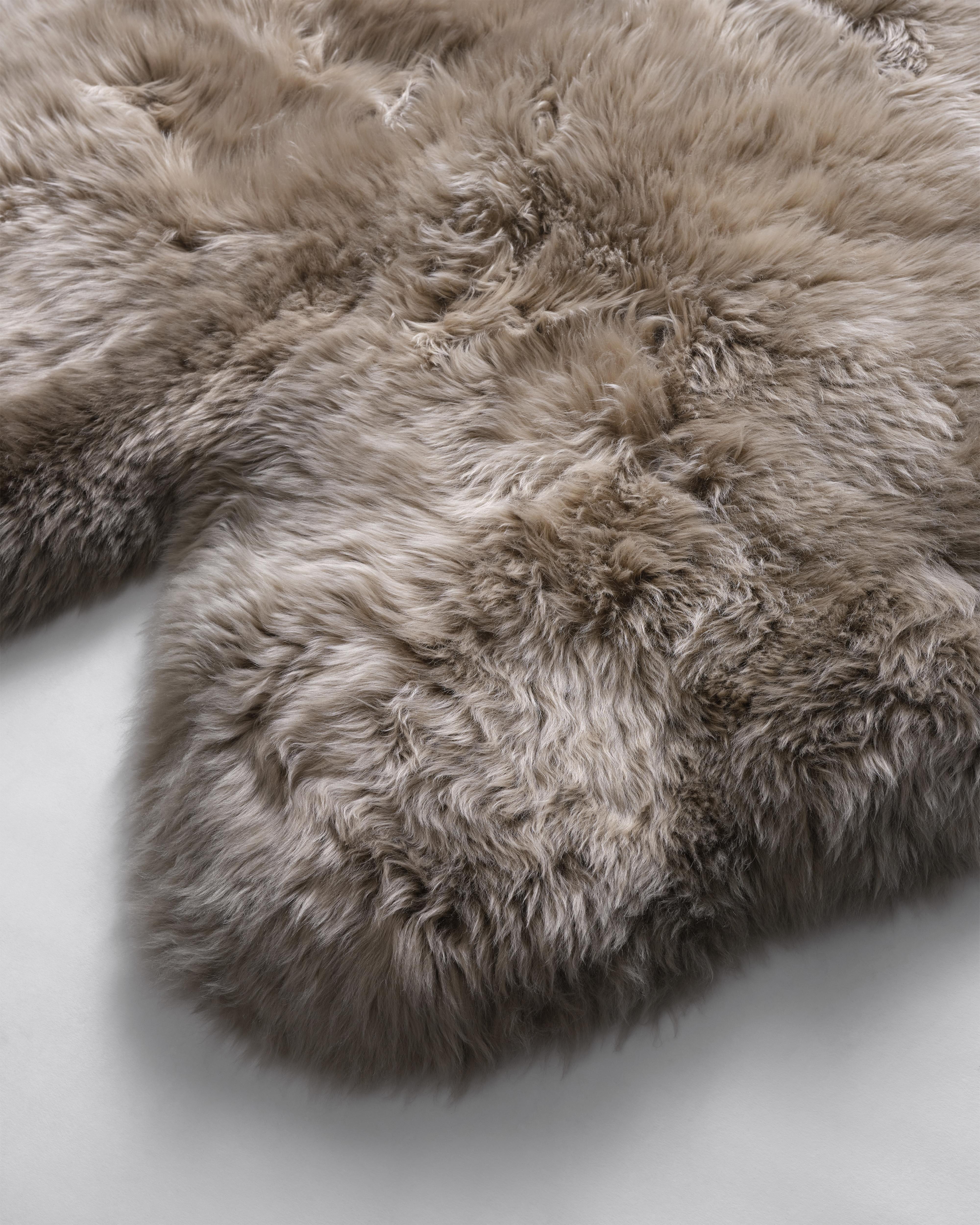 The naturalness and softness of a sheepskin rug can quickly elevate a room's beauty. On the floor, thrown over chairs and couches, this versatile design piece is a favorite of the Forsyth design team. 

This thick and beautiful sheepskin, dyed a