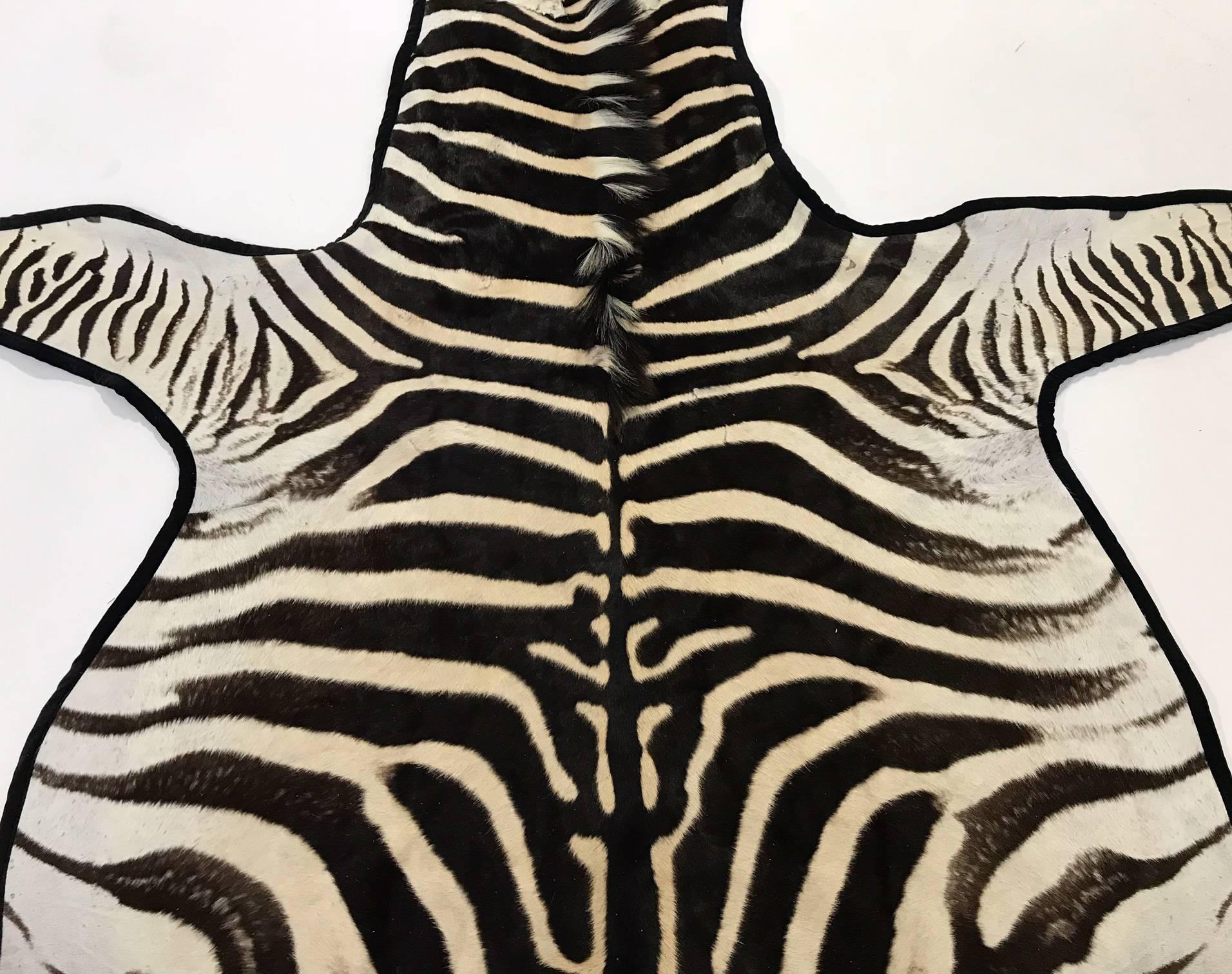 Forsyth master upholsterers trimmed this hand-selected zebra hide with our luxurious velvet and finished it with our khaki cotton canvas backing. We love the elegance the leather brings to the rug. 

Forsyth zebra hides are hand selected with a