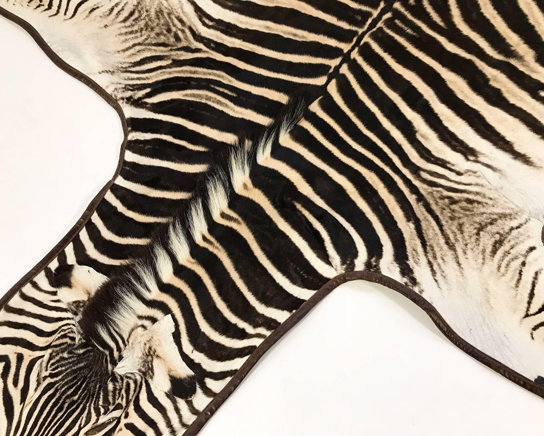 Forsyth master upholsterers trimmed this hand-selected zebra hide with our signature leather and finished it with our khaki cotton canvas backing. We love the elegance the leather brings to the rug. 

Forsyth zebra hides are hand selected with a