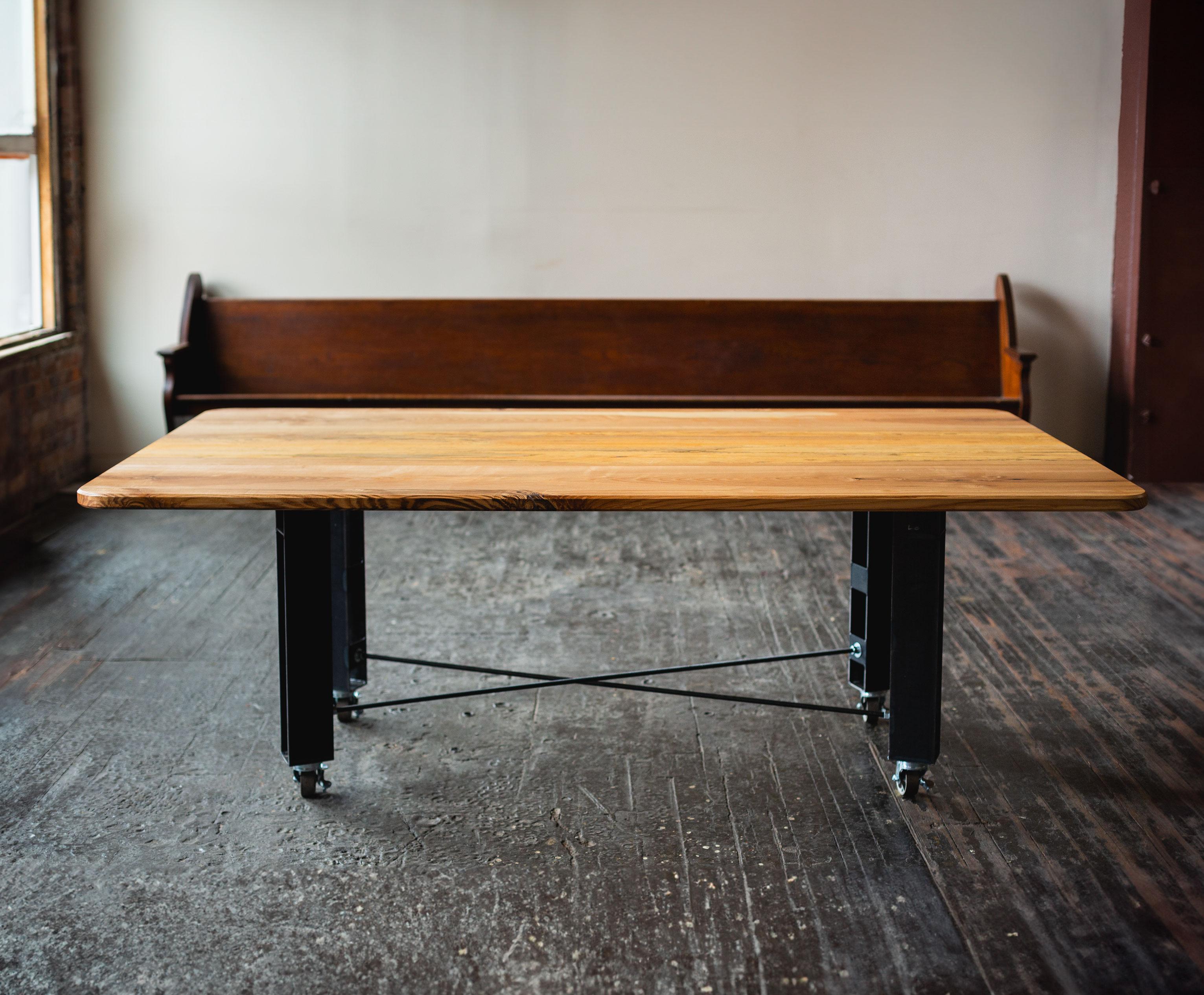 Modern table with an architectural influence, fit for home dining or office meetings.
Solid wood top, steel legs and industrial caster hardware.
Designed, built, and finished in our studio from start to finish.

DIMENSIONS
84” long x 48” wide x 30”